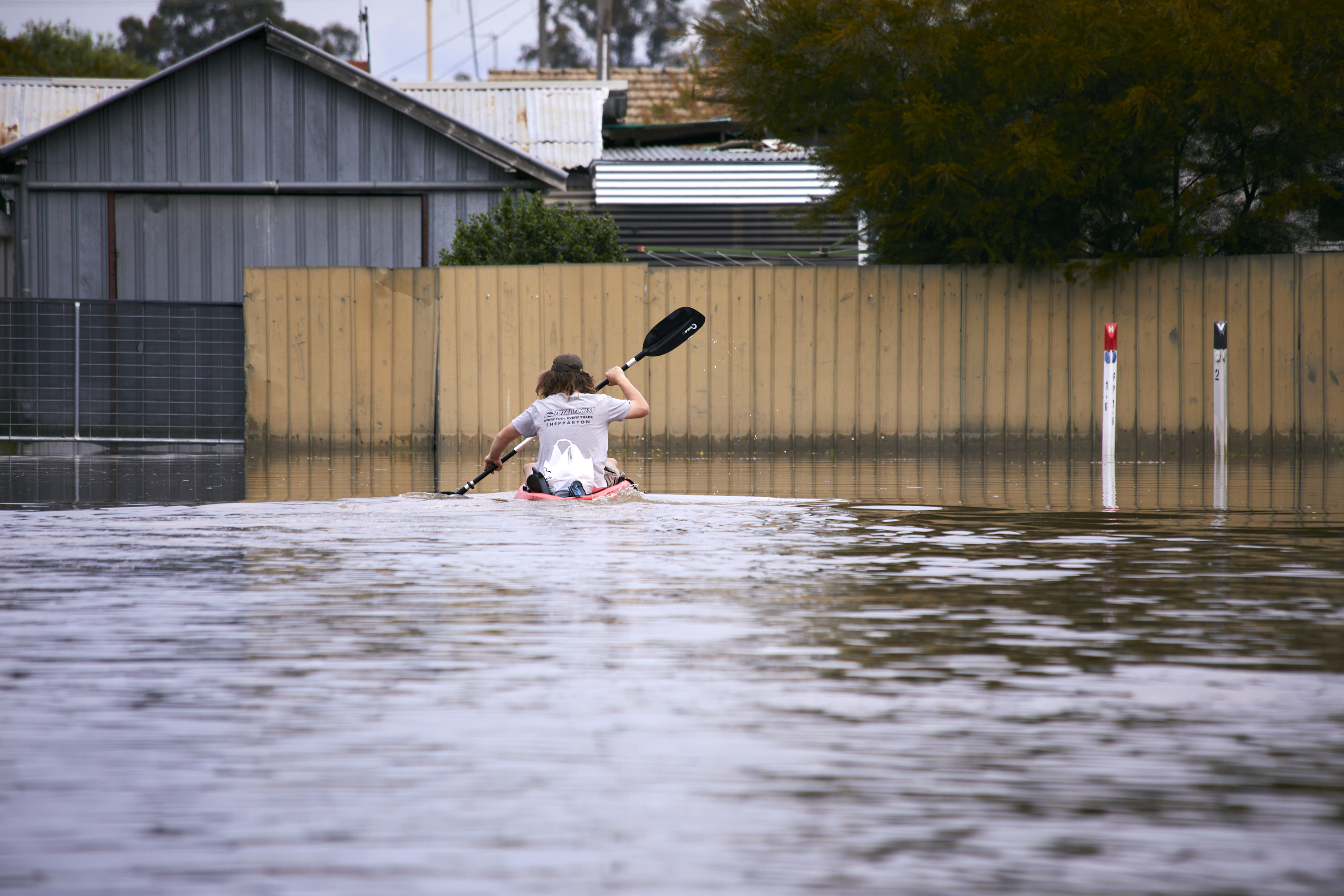 Bodi Fitzsimmons kayaking down the street during the floods in Shepparton, Victoria.