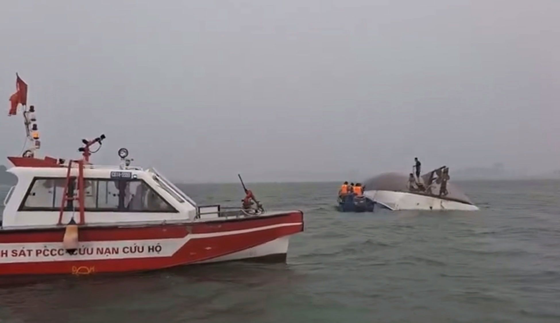 A search party searches Ha Long Bay after a tourist boat capsized.