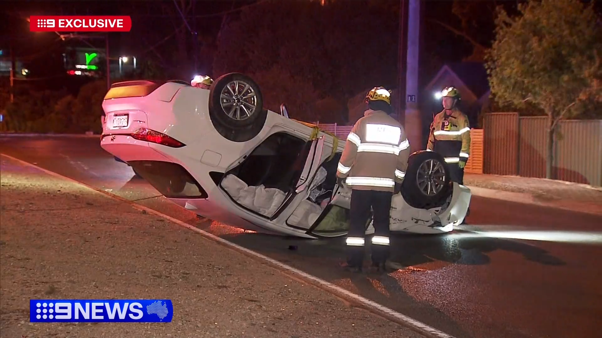 The car was flipped on its roof after crashing through the roundabout.
