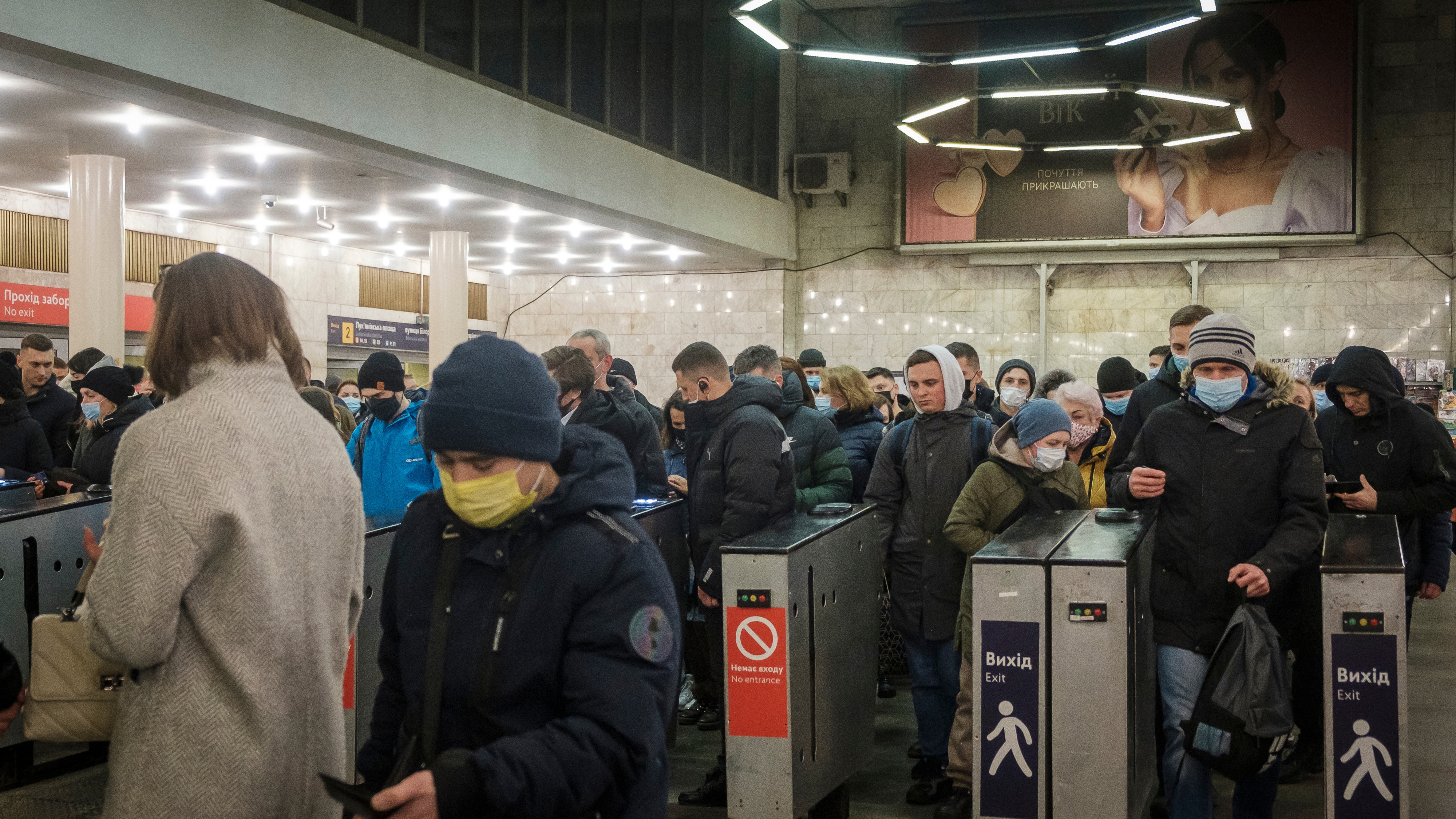 Commuters pass though fare gates at the Lukyanivska Metro station in Kyiv, Ukraine.