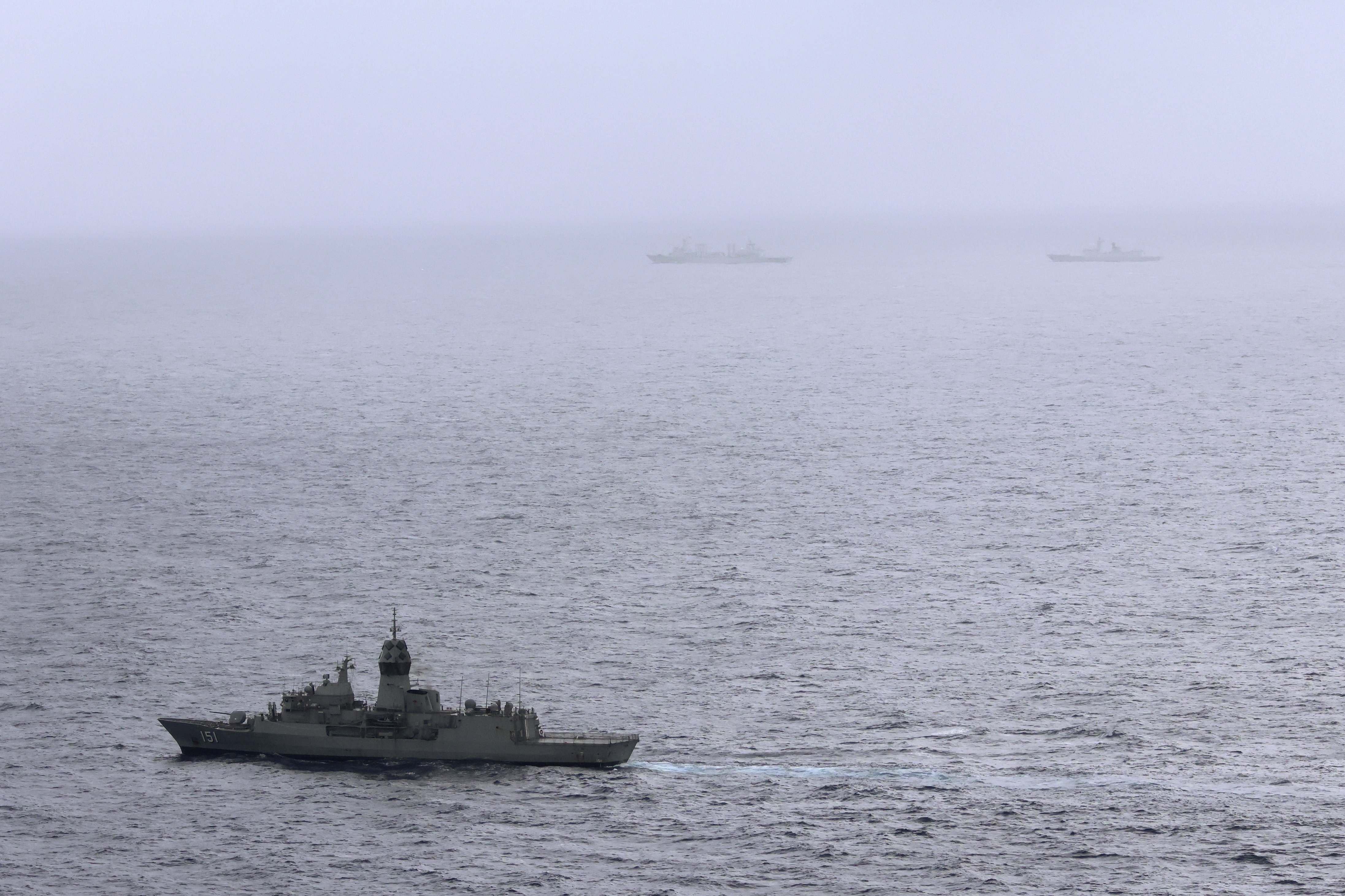 The HMAS Arunta, left, shadows the People's Liberation Army-Navy Jiangkai-class frigate Hengyang and a Fuchi-class replenishment vessel in the Tasman Sea, on Feb. 13, 2025.