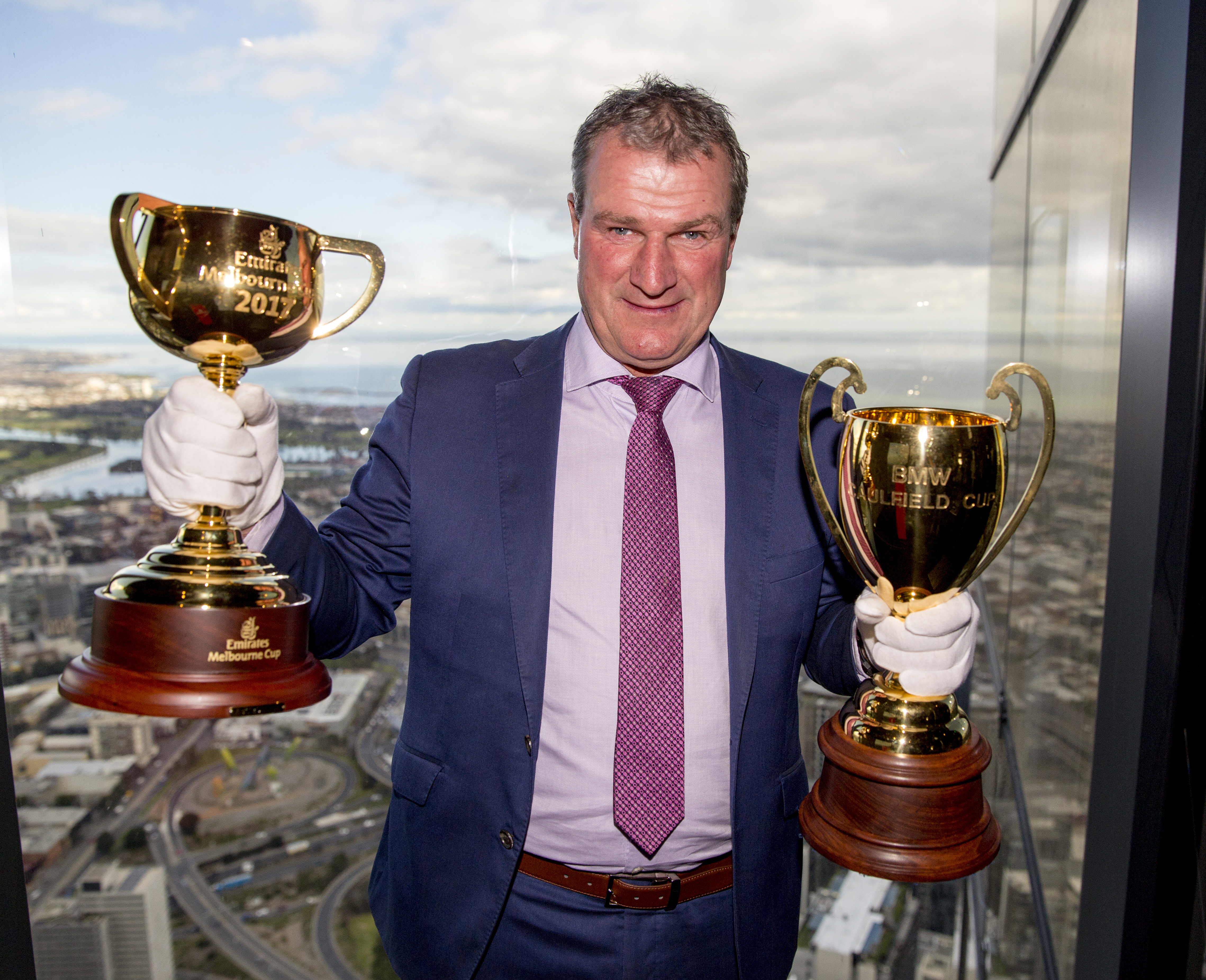 Darren Weir, Melbourne Cup-winning trainer with the 2017 Emirates Melbourne Cup trophy and the    2017 BMW Caulfield Cup trophy at Eureka Tower on August 29, 2017 in Melbourne, Australia. (Fiona Hamilton /Racing Photos)