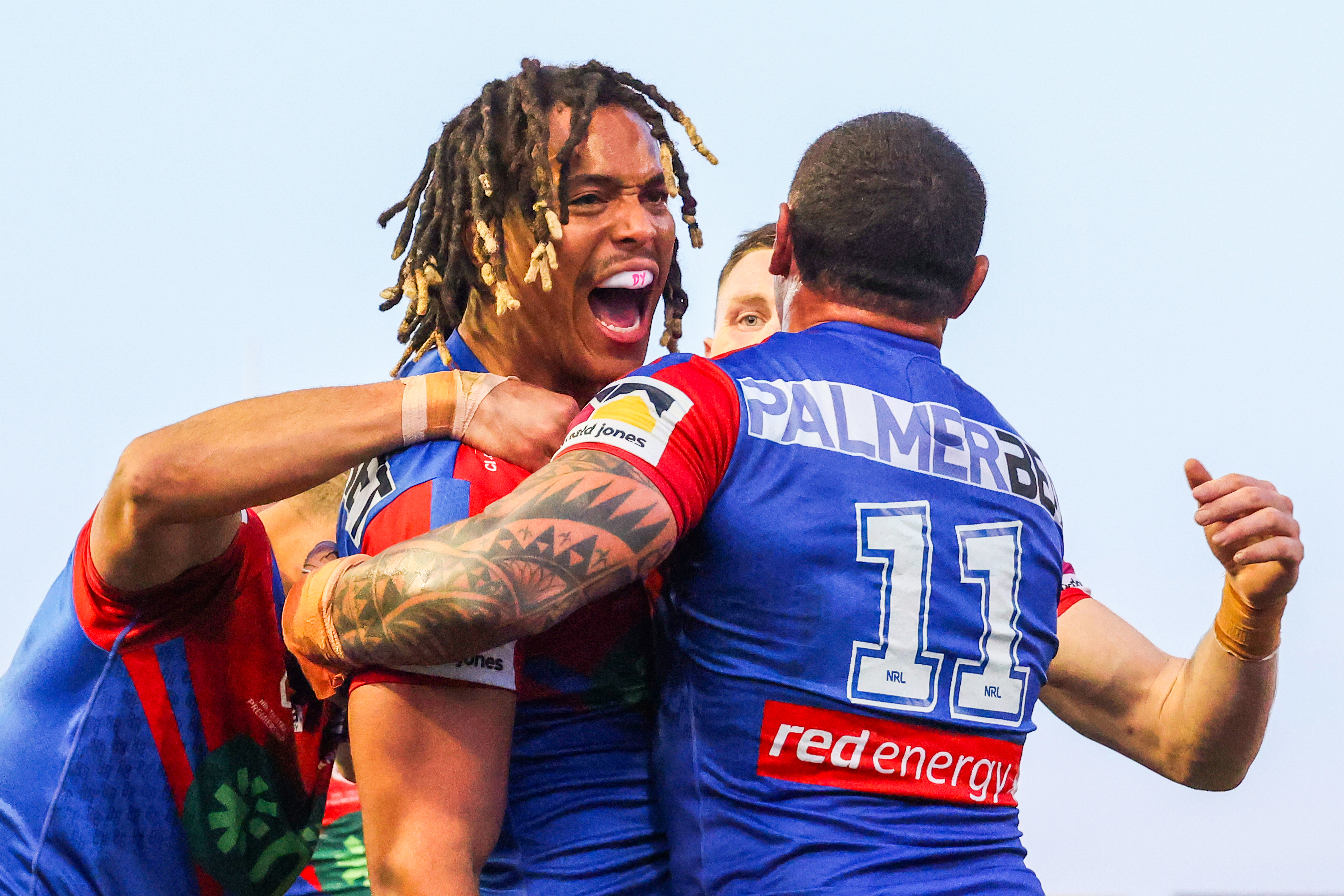 NEWCASTLE, AUSTRALIA - AUGUST 27: Dominic Young of the Knights celebrates a try with team mates during the round 26 NRL match. between Newcastle Knights and Cronulla Sharks at McDonald Jones Stadium on August 27, 2023 in Newcastle, Australia. (Photo by Jenny Evans/Getty Images)