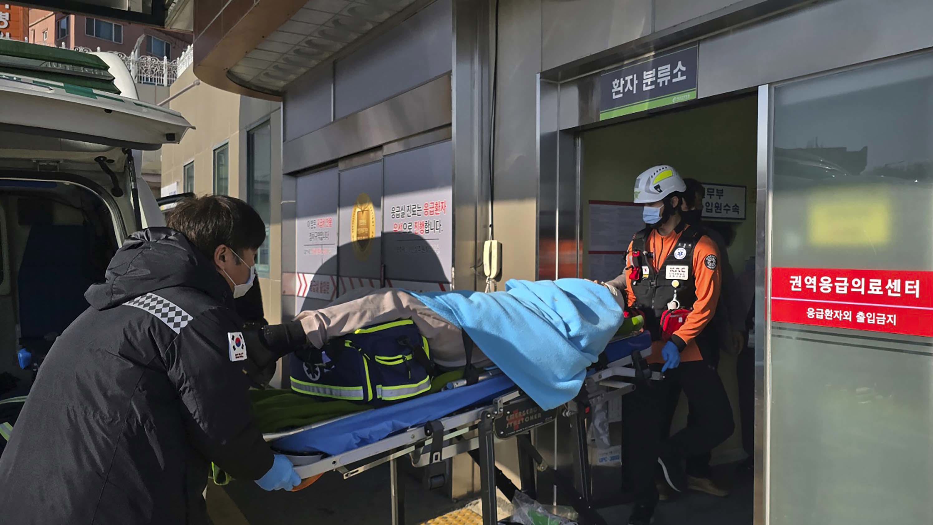 A victim rescued from a plane crash is transported to a hospital in Mokpo, South Korea, 