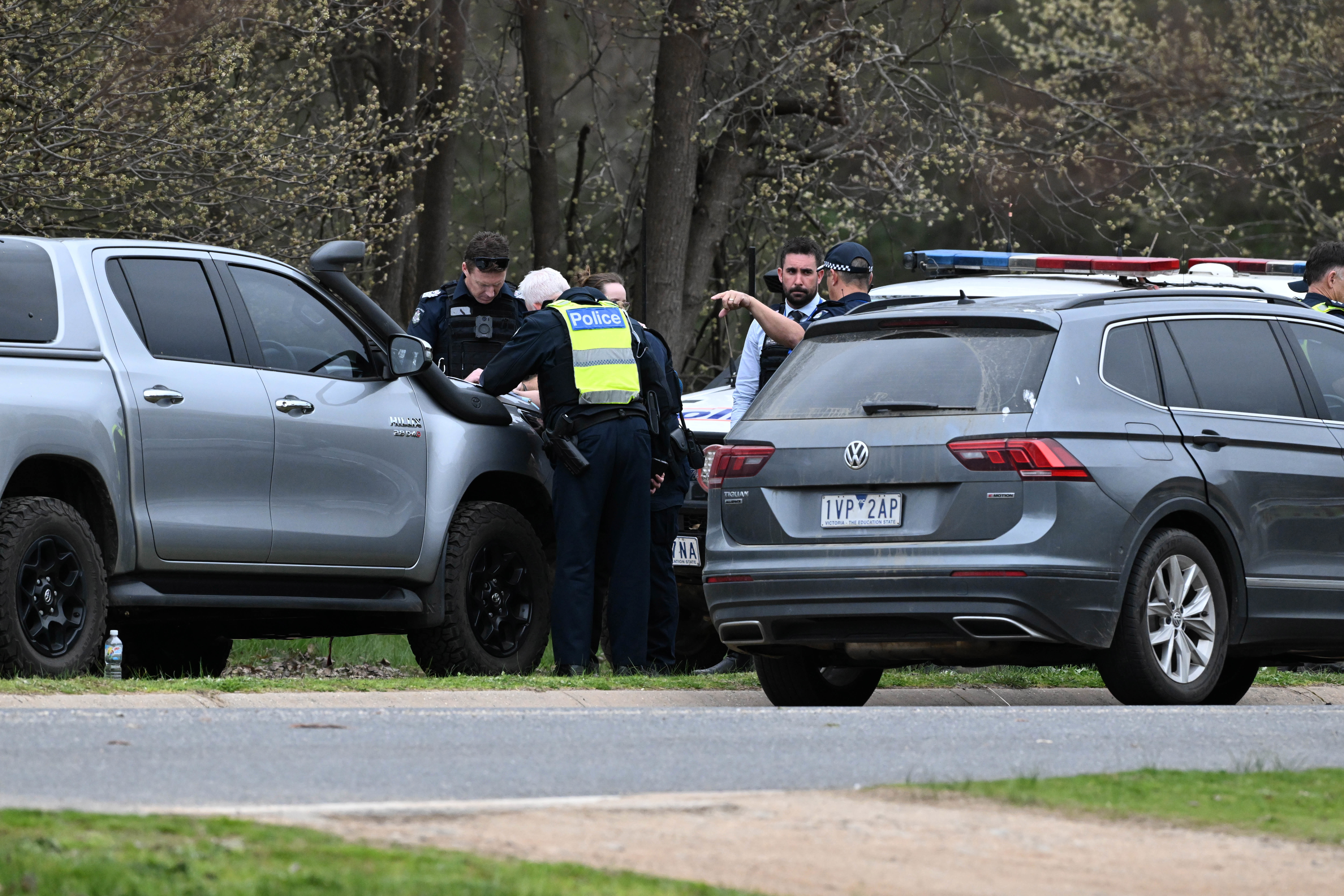 Police at the scene in Porepunkah, where two officers were shot dead and another injured while serving a warrant.