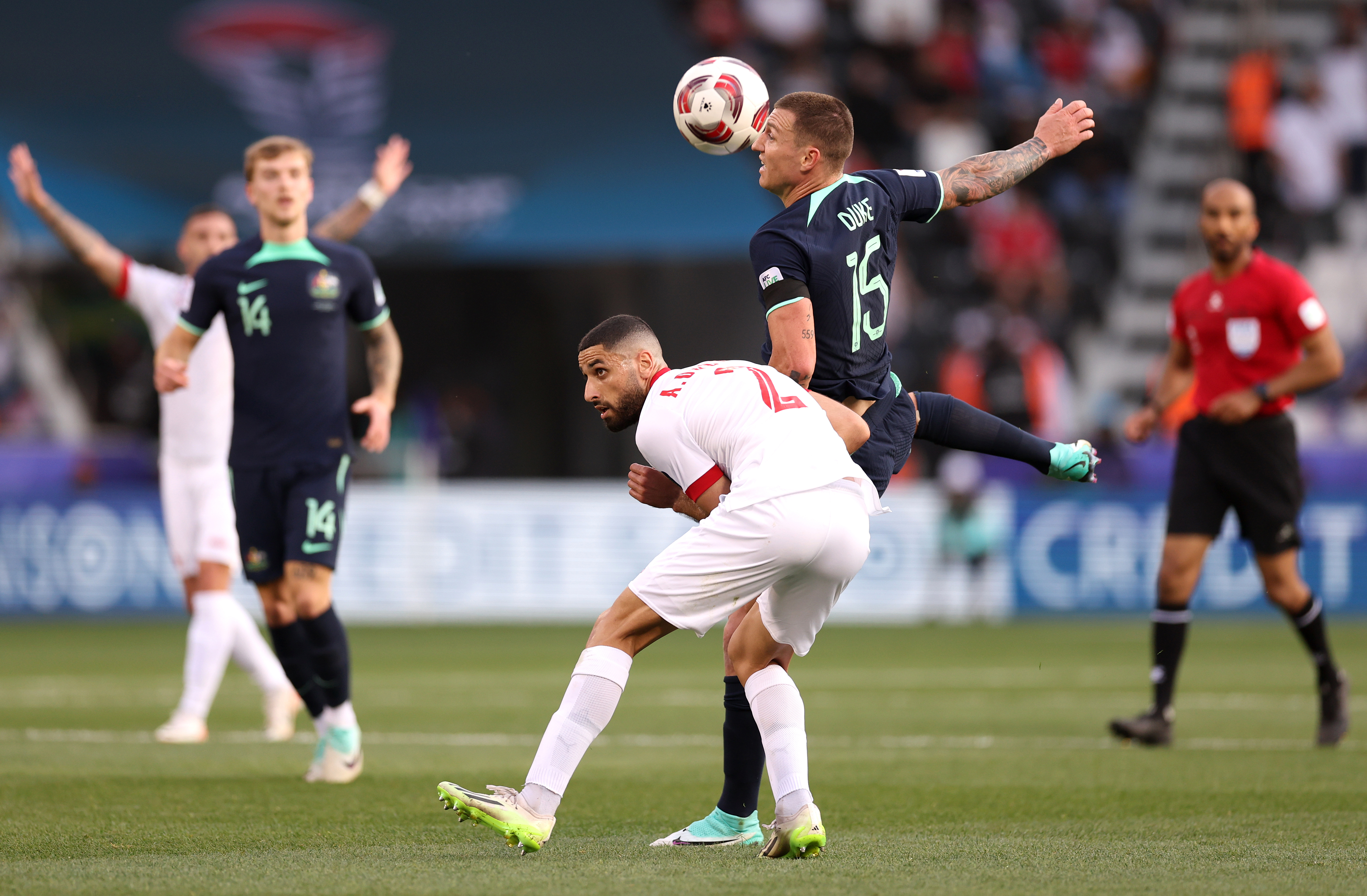 Mitchell Duke of Australia battles for possession with Aiham Ousou of Syria.