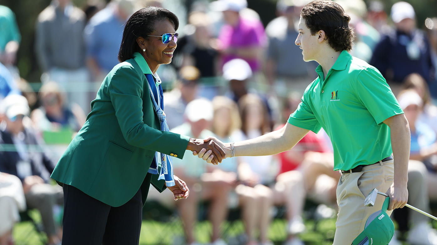 Former United States Secretary of State Condoleezza Rice shakes hands with Jacob Olearczyk of the Boys 14-15 group at the Drive, Chip and Putt Championship.