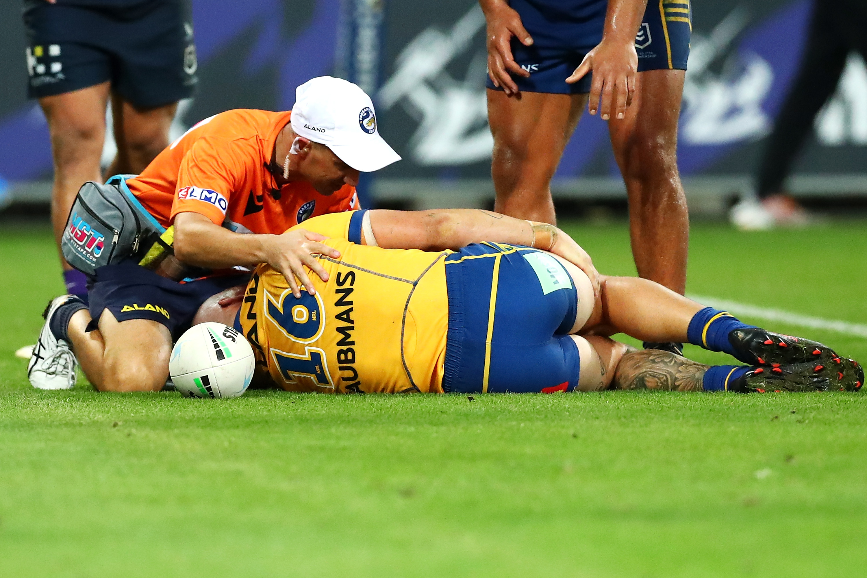 Ray Stone of the Eels receives attention from the trainer after scoring the match winning try.