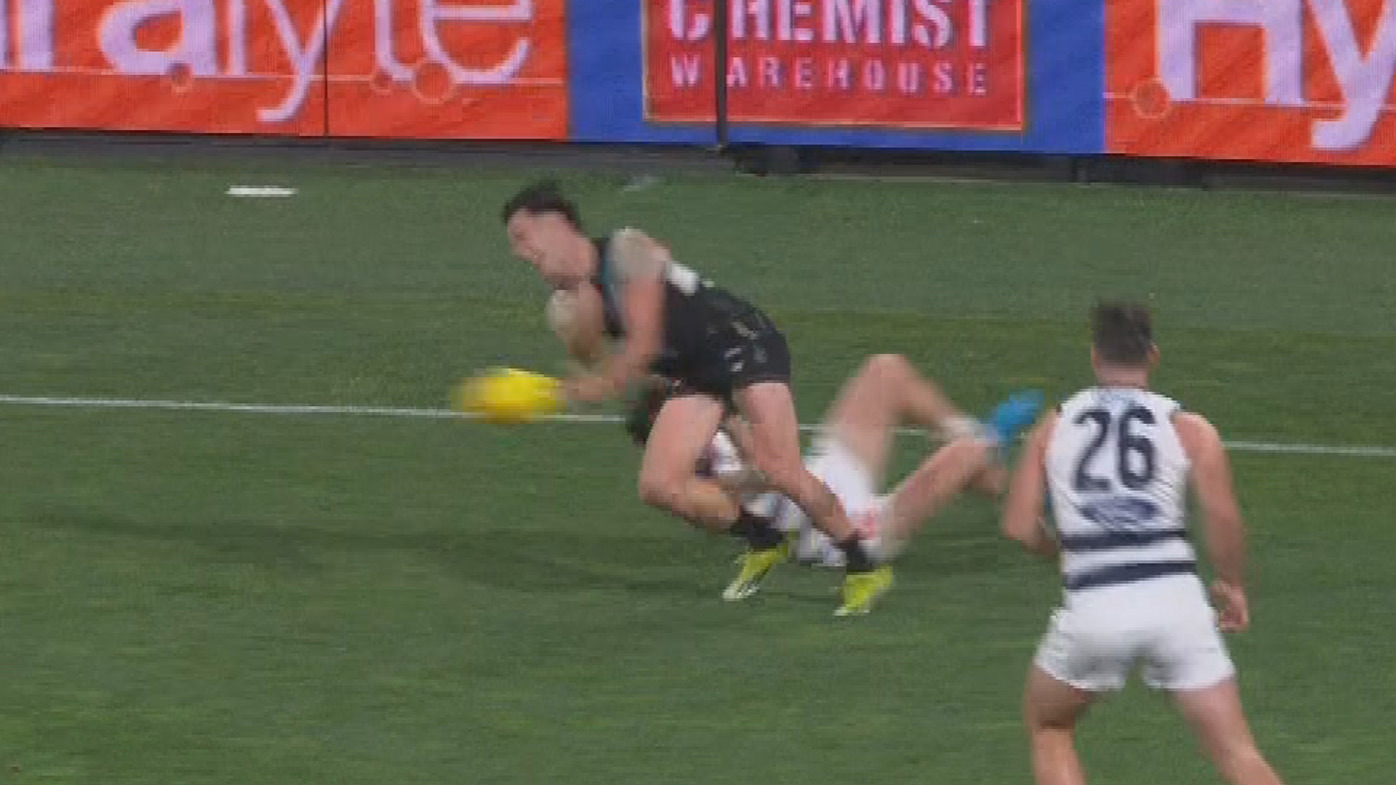 Umpires called a holding the ball free kick to Geelong after this contest late against Port Adelaide.