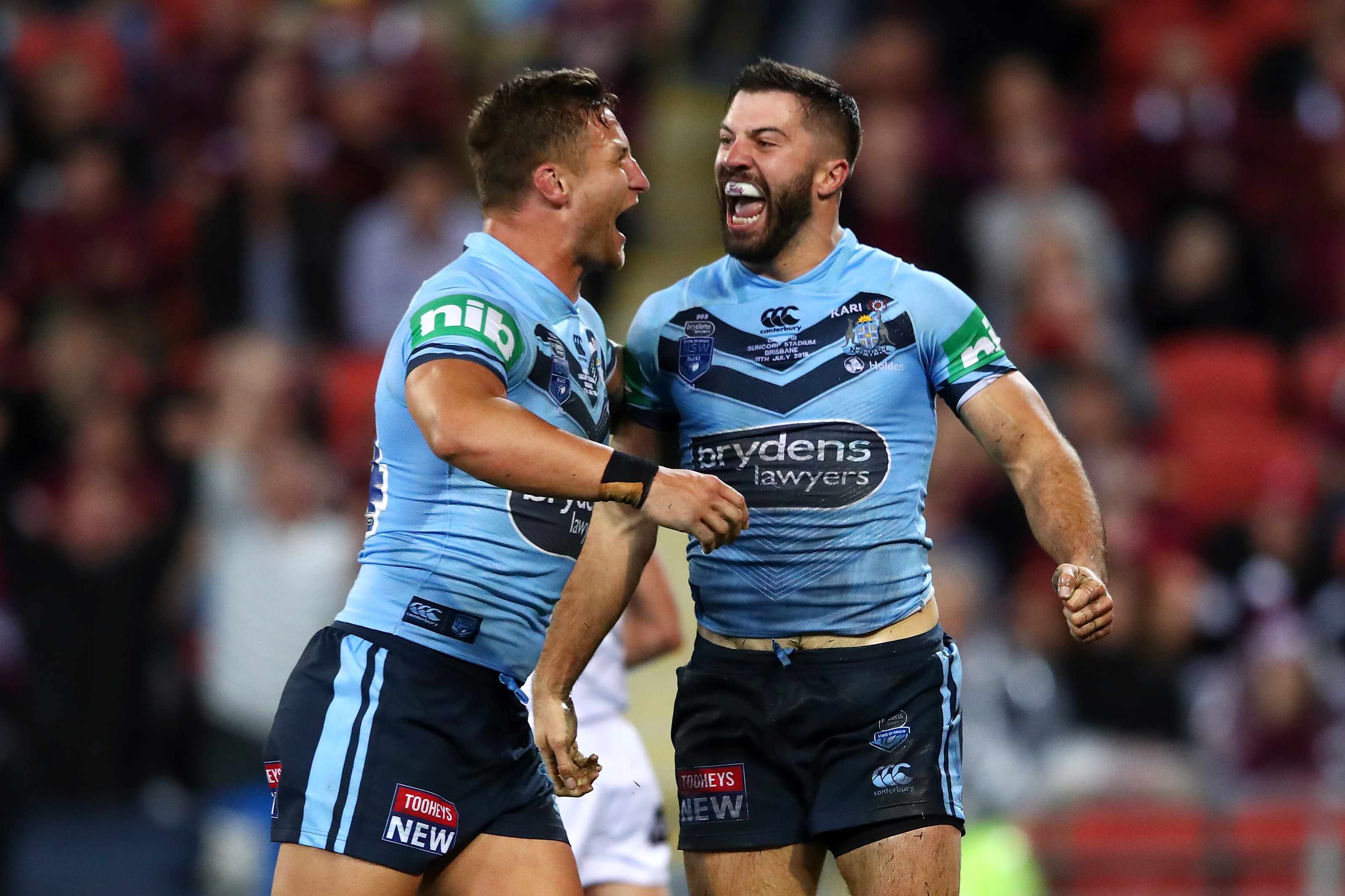 Tariq Sims and James Tedesco celebrate a NSW Blues victory.