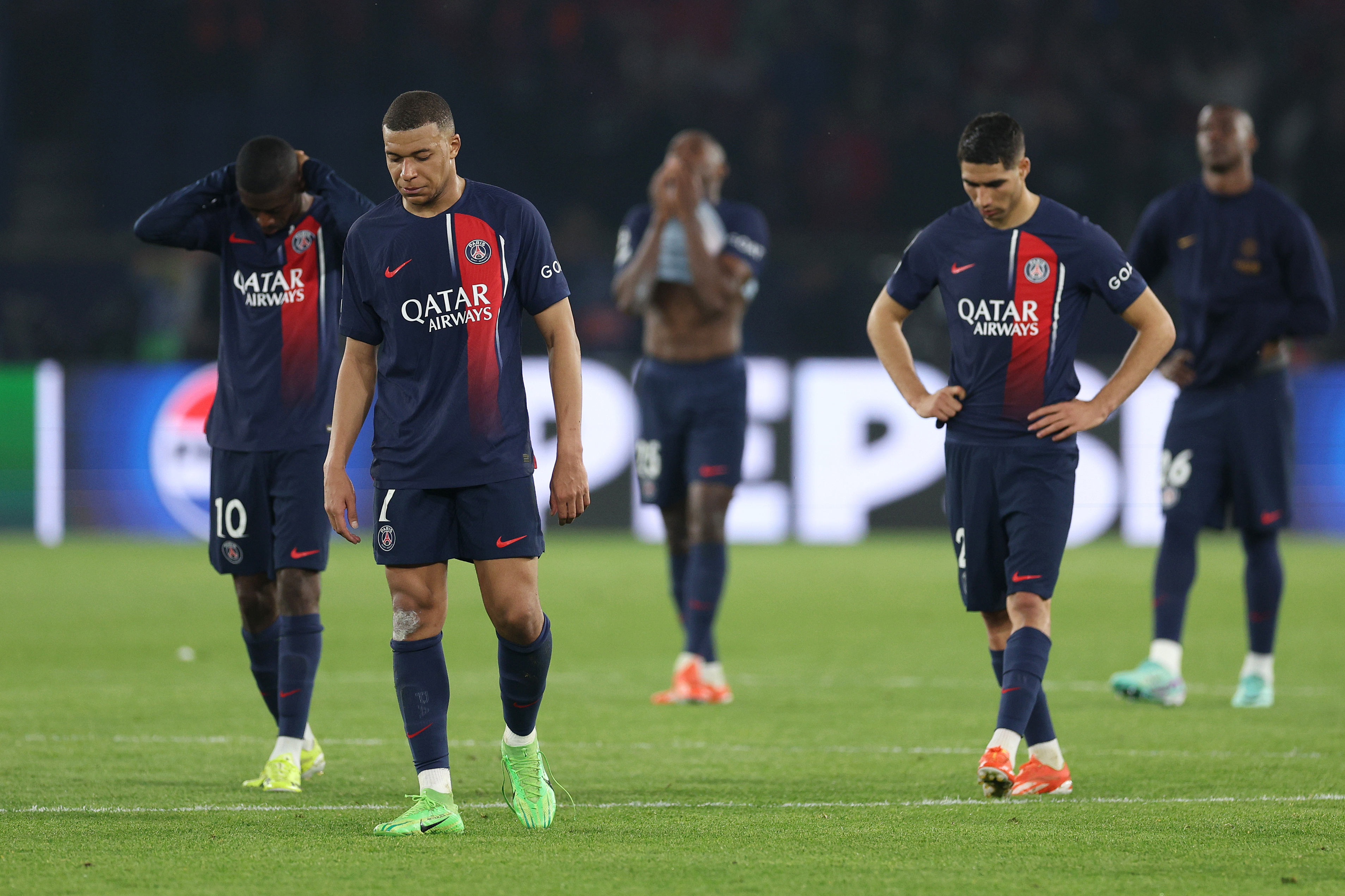 Kylian Mbappe of Paris Saint-Germain looks dejected with teammates after defeat to Borussia Dortmund during the UEFA Champions League semi-final second leg match between Paris Saint-Germain and Borussia Dortmund at Parc des Princes.