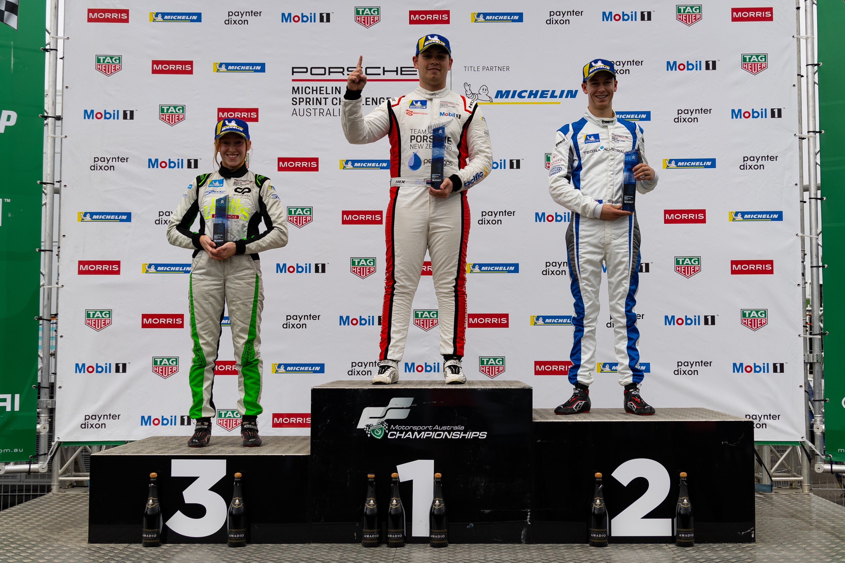 Courtney Prince (left) stands on the podium next to Ryan Wood (centre) and Tom Sargeant (right) at Sandown.