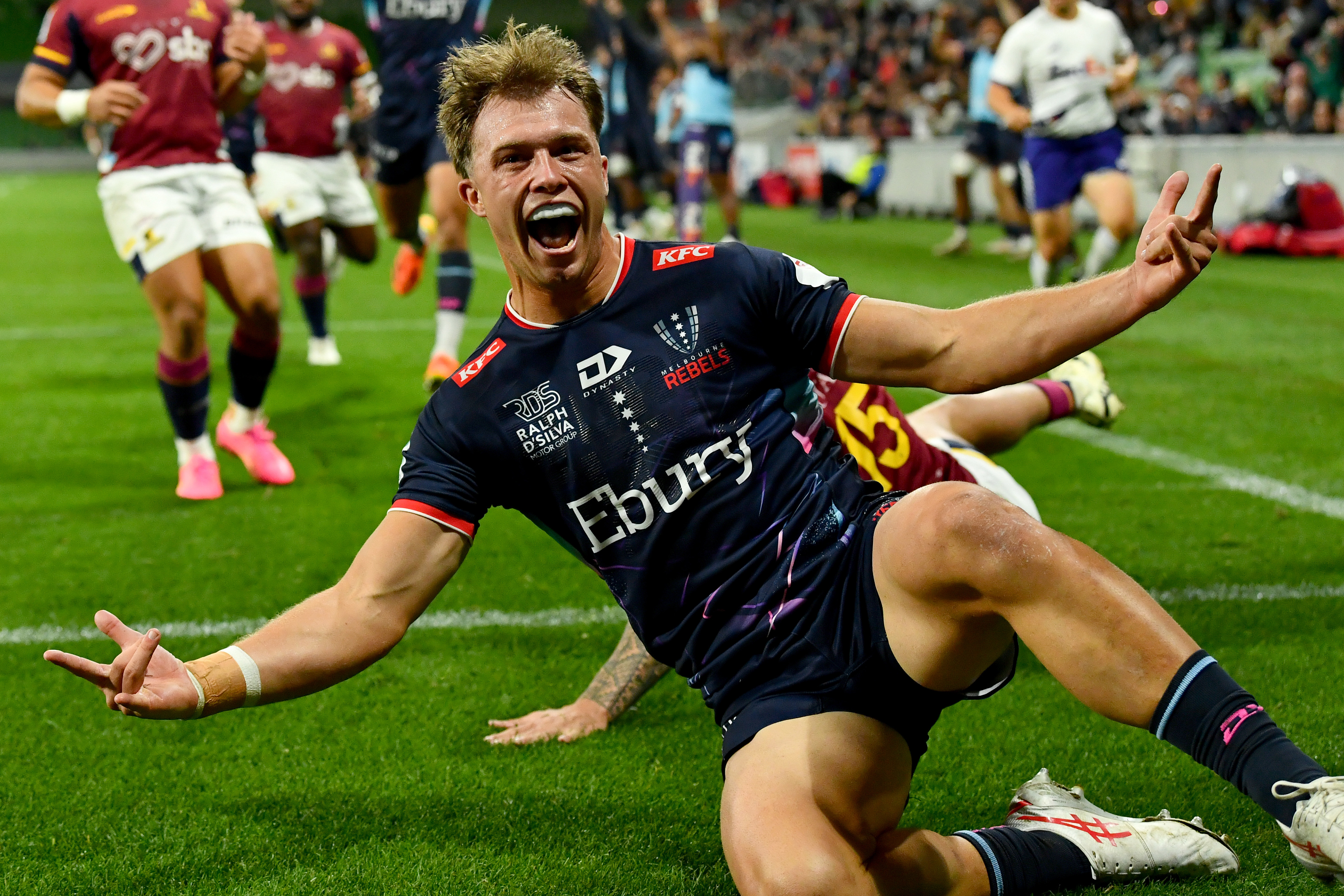 Darby Lancaster of the Rebels celebrates scoring a try.