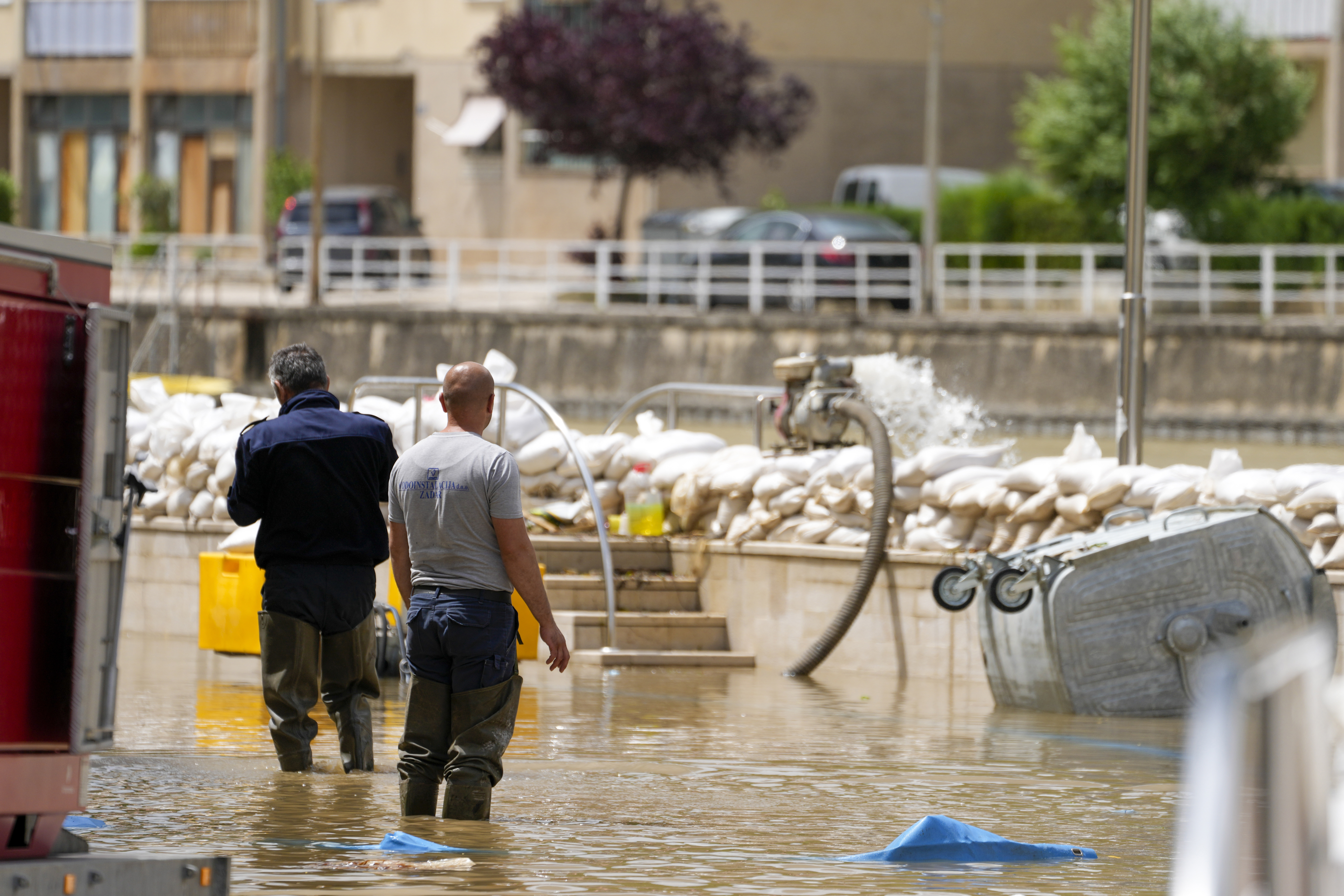 Members of civil defence pump flooding waters back into Zrmanja river in Obrovac, Croatia, Tuesday, May 16, 2023. 