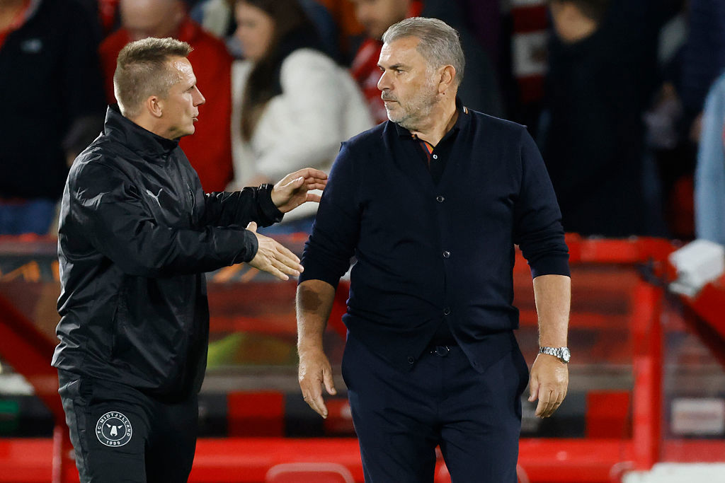 Midtjylland coach Mike Tullberg goes to shake hands with Ange Postecoglou.