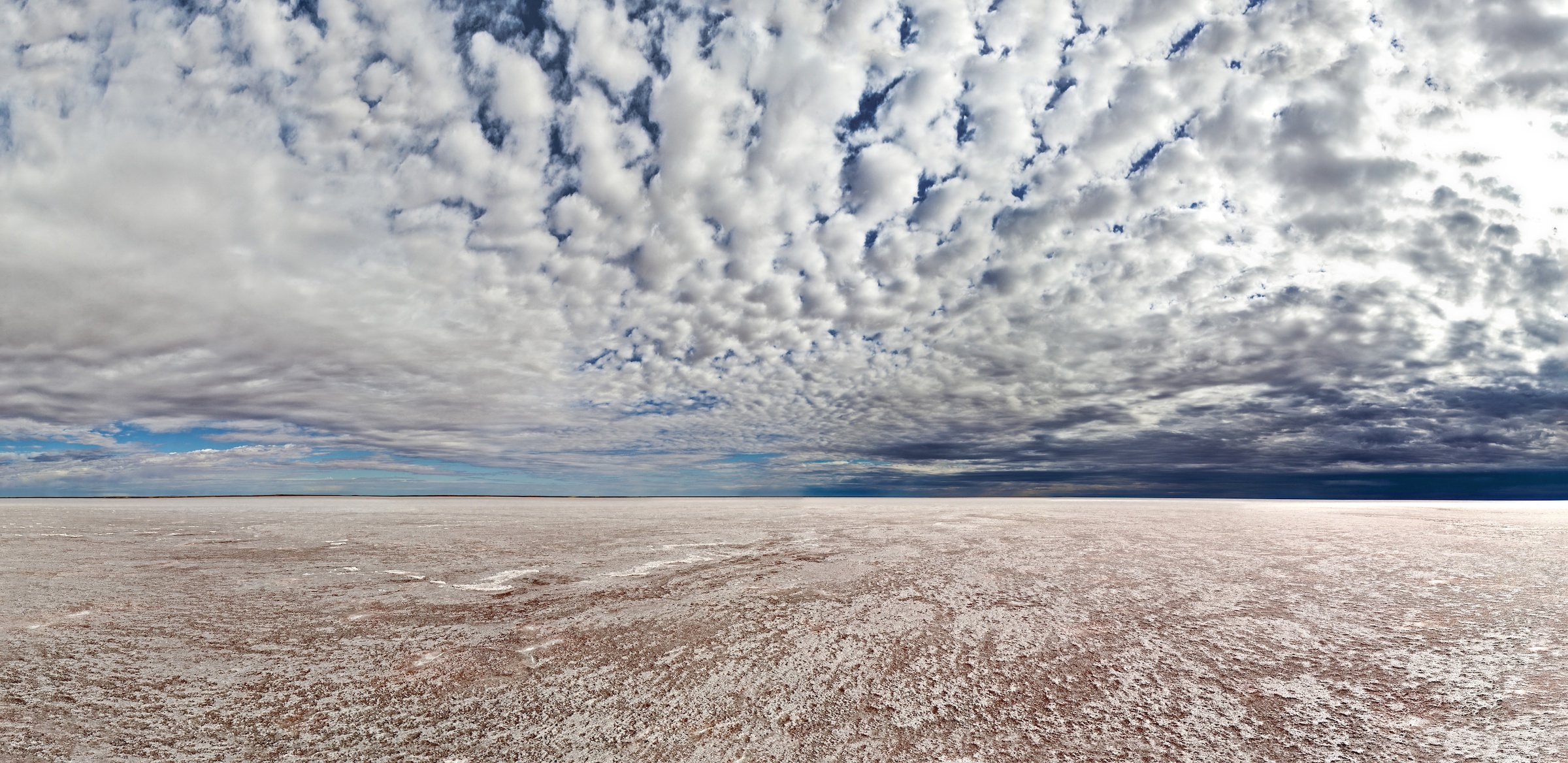 ﻿Kati Thanda-Lake Eyre is a dry salt bed in the lowest point in Australia, sitting 15 metres below sea level, and covers about 9500 square kilometres.
