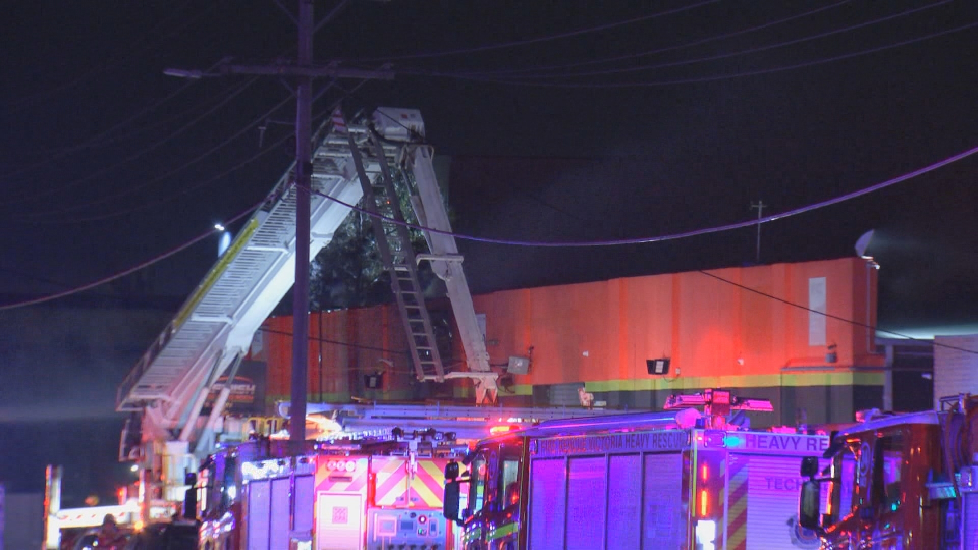 A fire ripped through an automotive business in Melbourne overnight after a car crashed into the building.