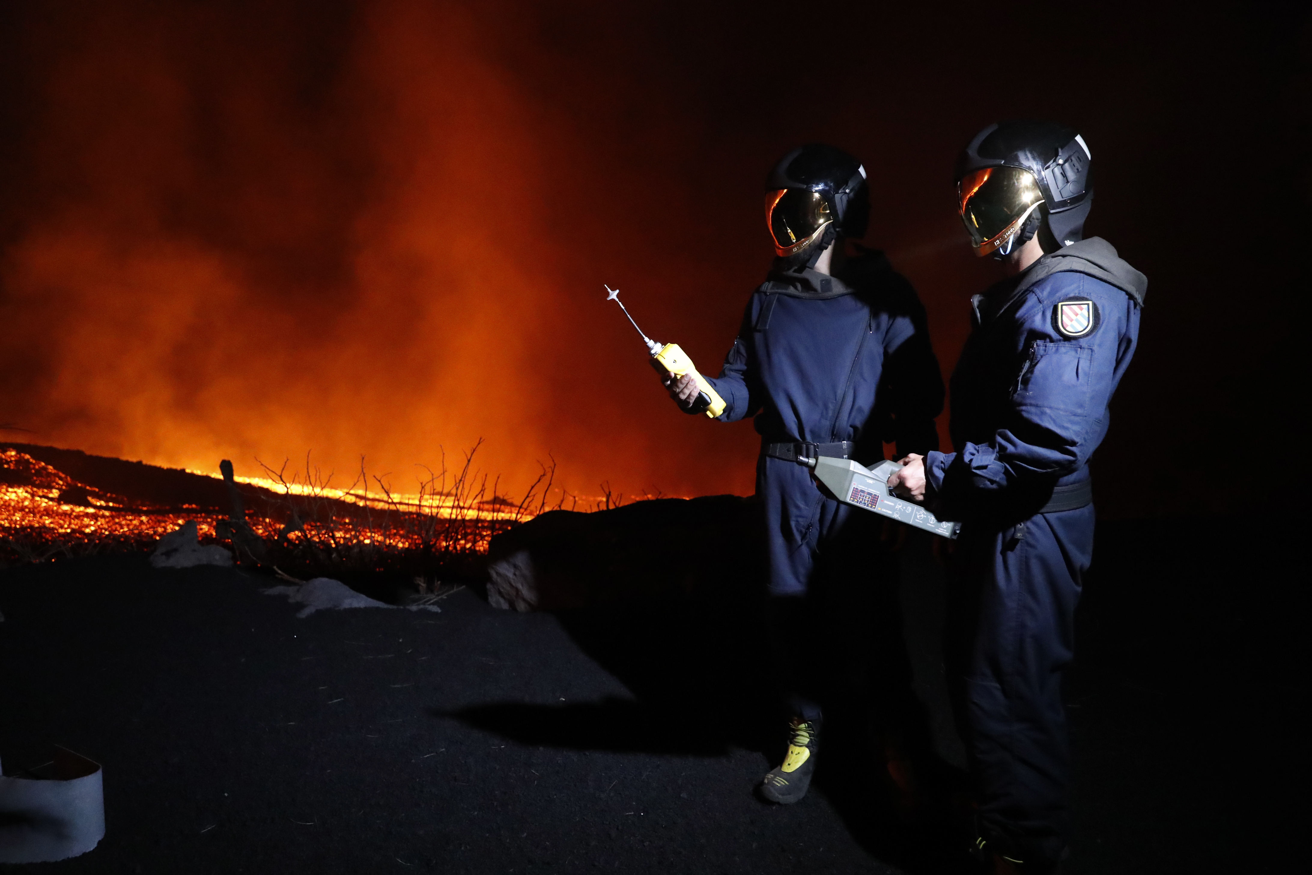 Military Emergency Unit personal take gas reading measurements near a volcano on the Canary island. 