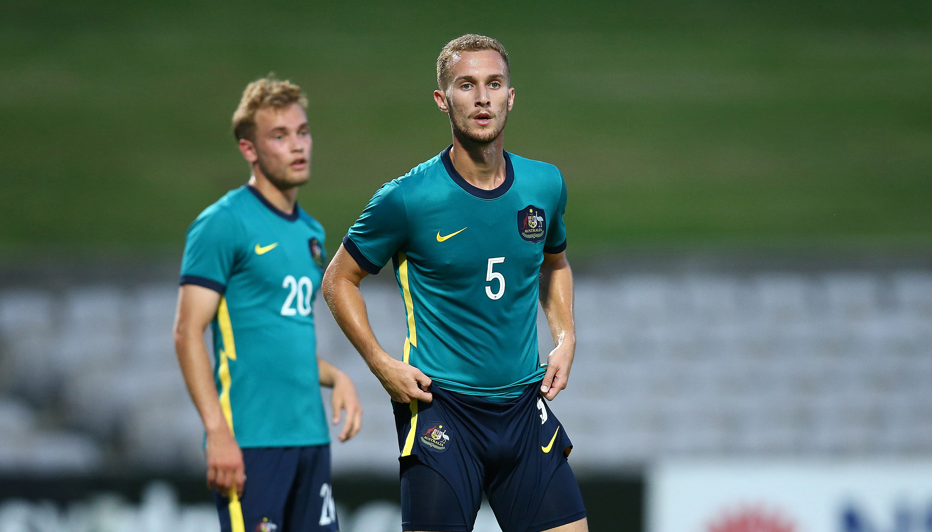 Tass Mourdoukoutas of the Olyroos looks on.