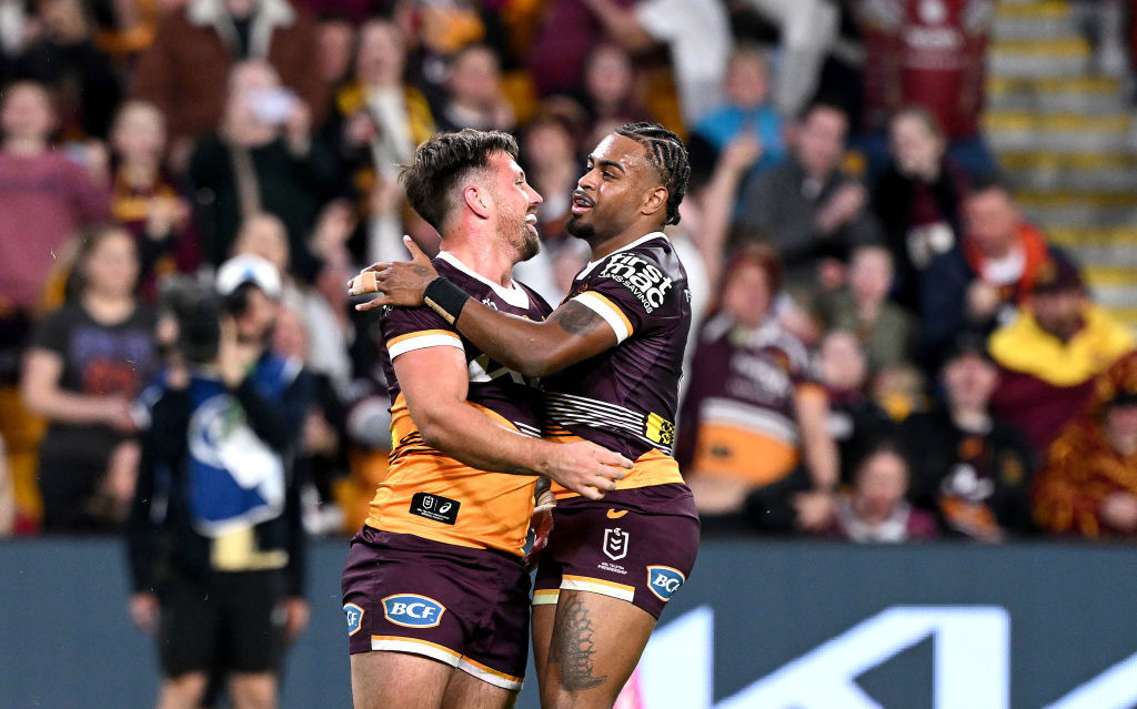 Tyson Smoothy of the Broncos is congratulated by teammate Ezra Mam after scoring a try.