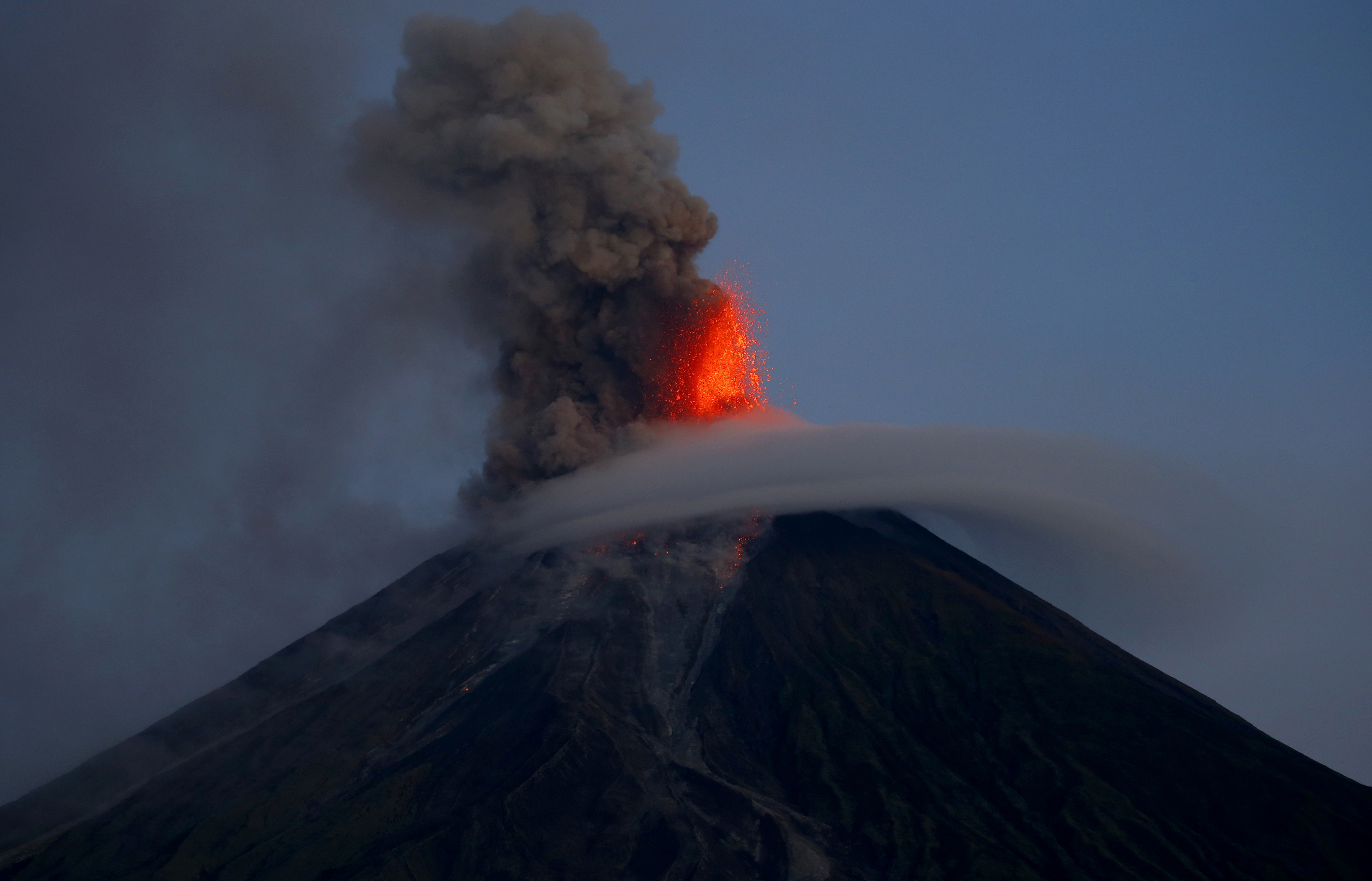 Mayon volcano spews red-hot lava in another eruption as seen from Legazpi city, Albay province around 200 miles (340 kilometers) southeast of Manila, Philippines Wednesday, Jan. 24, 2018. 