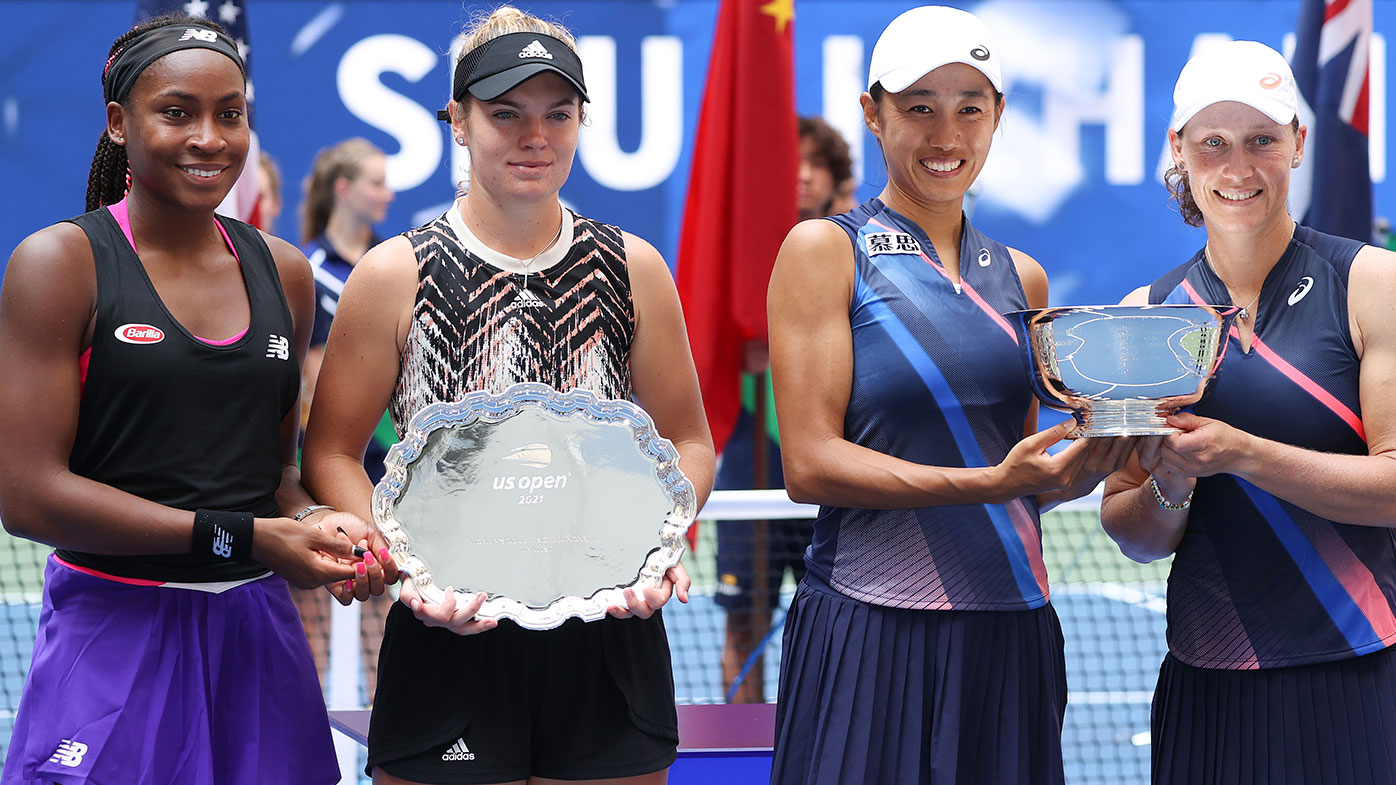 Coco Gauff of the United States and Catherine McNally of the United States smile with the runner-up trophy alongside Shuai Zhang of China and Samantha Stosur of Australia who celebrate with the championship trophy after their Women's Doubles final match on Day Fourteen of the 2021 US Open at the USTA Billie Jean King National Tennis Center on September 12, 2021 in the Flushing neighborhood of the Queens borough of New York City. (Photo by Al Bello/Getty Images)