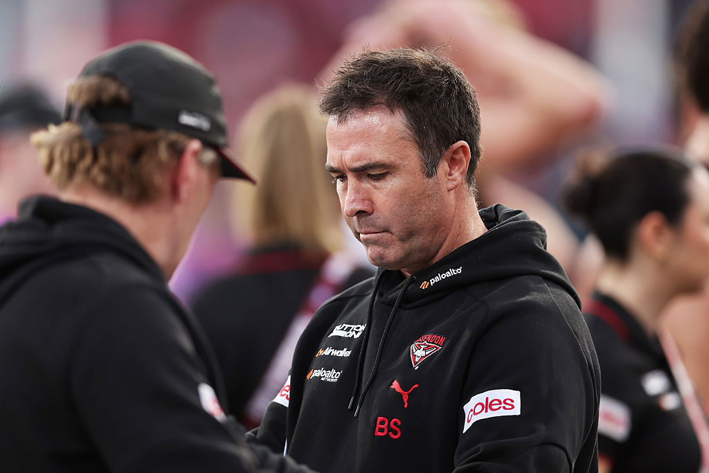 Bombers head coach Brad Scott looks on.
