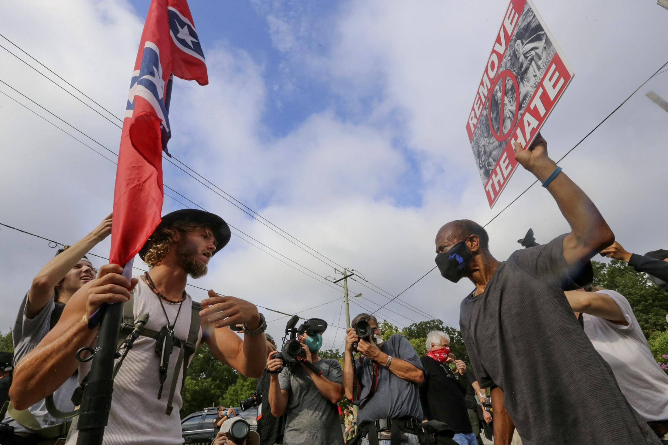Protestors and counter protestors face off Saturday, Aug. 15, 2020, in Stone Mountain Village