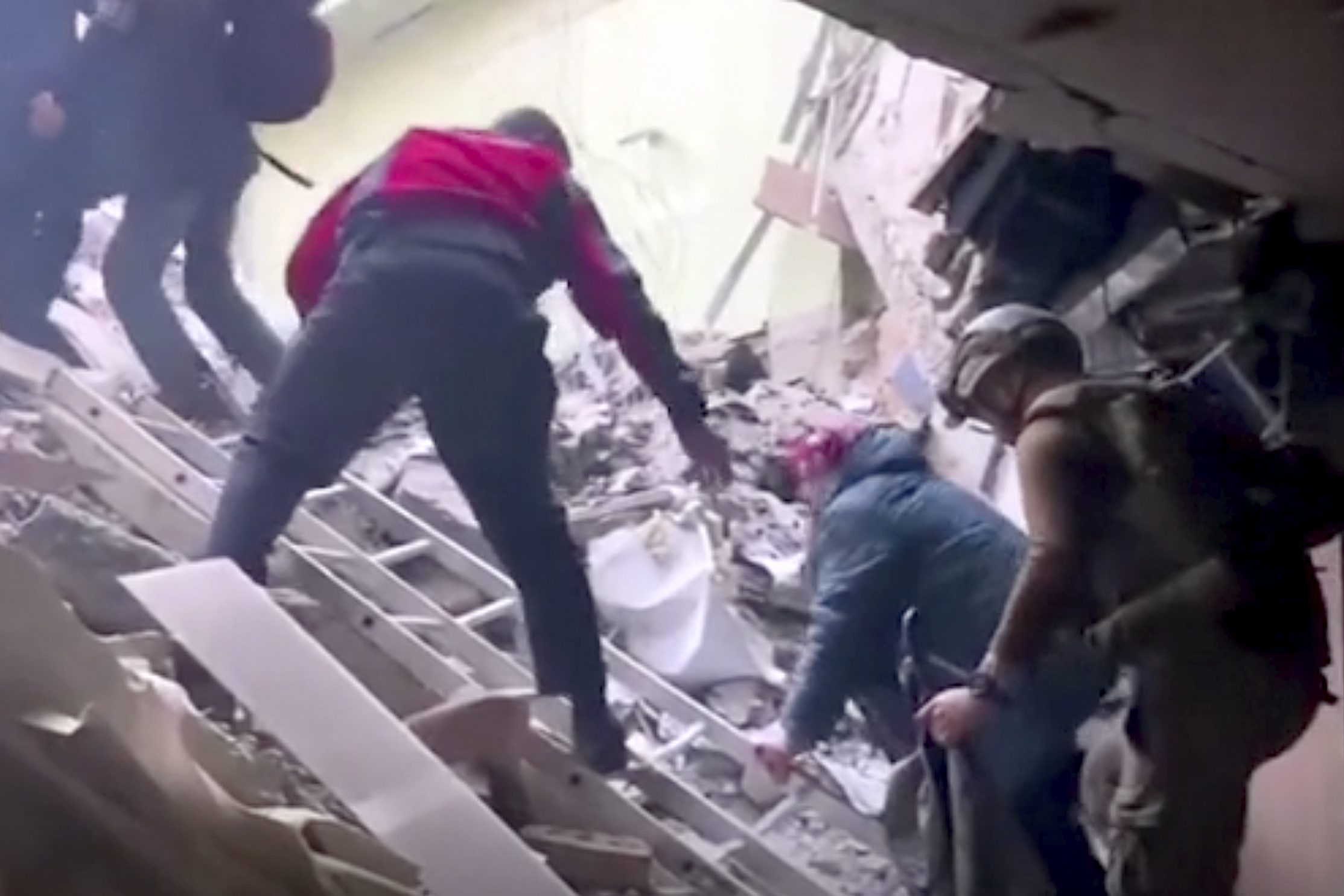 This frame taken from an undated video provided Sunday, May 1, 2022 by the Azov Special Forces Regiment of the Ukrainian National Guard shows people climbing over debris at the Azovstal steel plant, in Mariupol, eastern Ukraine.   As many as 100,000 people may still be in Mariupol, including an estimated 2,000 Ukrainian fighters beneath the sprawling, Soviet-era steel plant  the only part of the city not occupied by the Russians. (Azov Special Forces Regiment of the Ukrainian National Guard via 