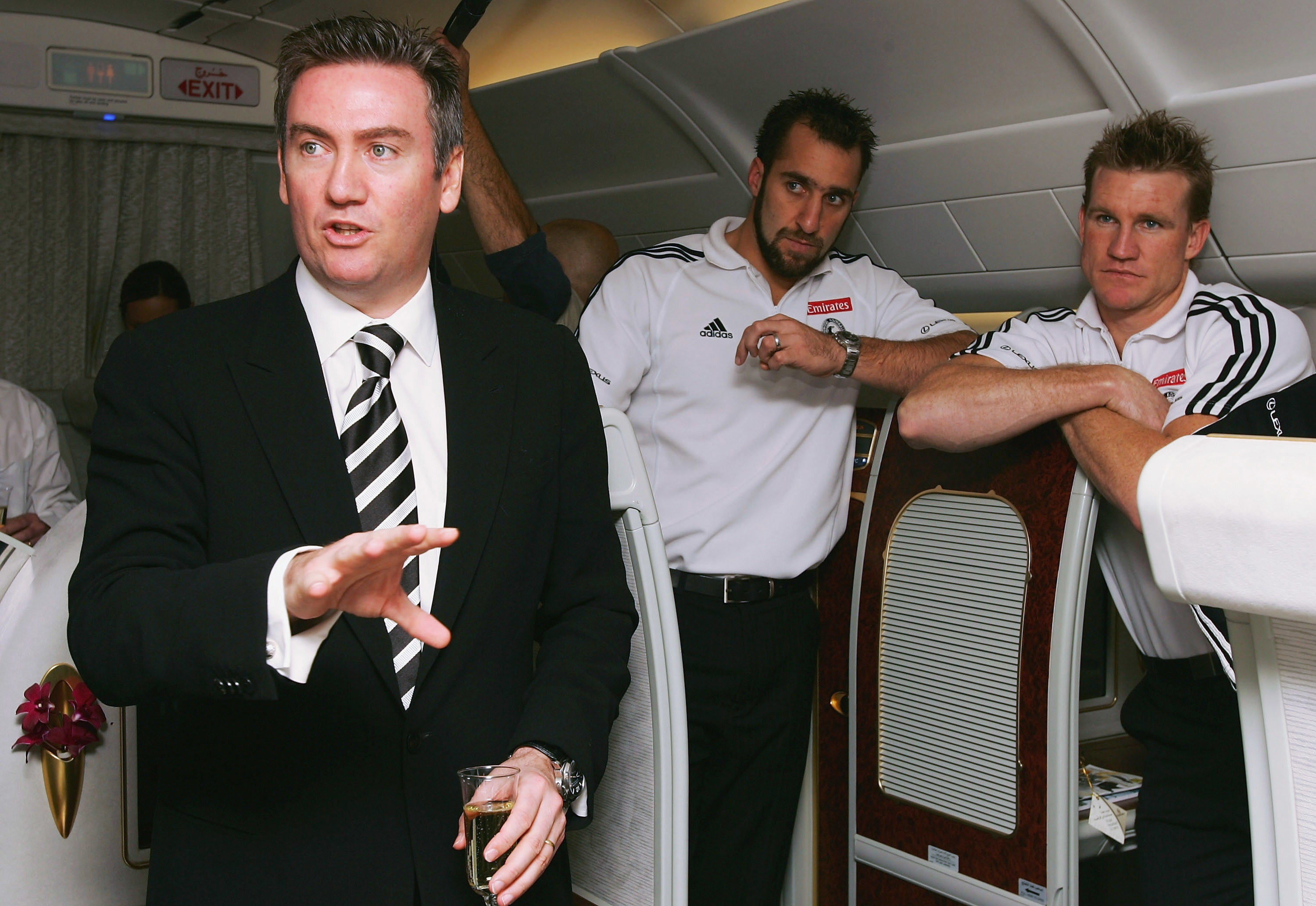 Eddie McGuire speaks with Collingwood players Anthony Rocca and Nathan Buckley in 2005.