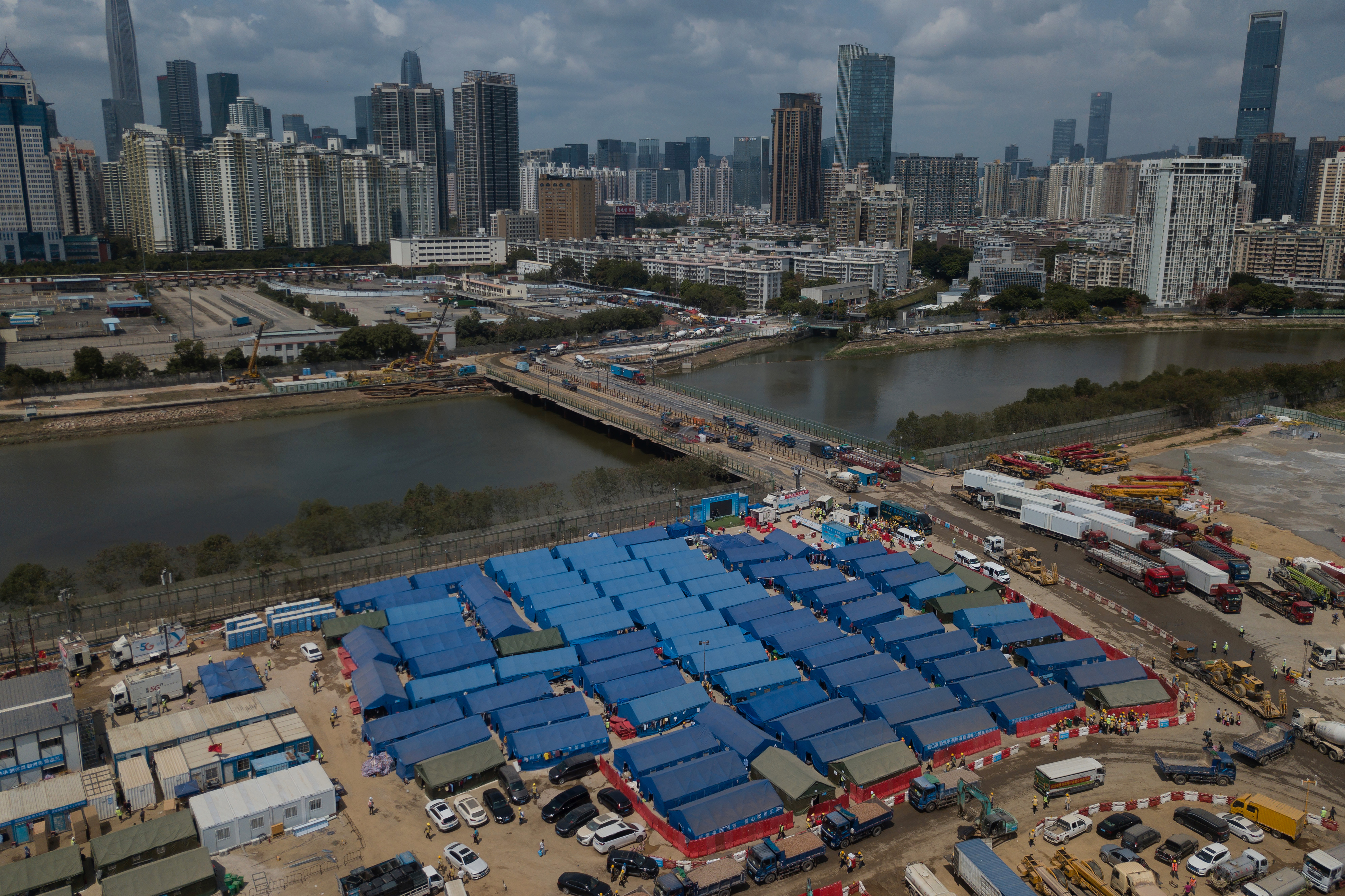 An aerial view shows a construction site for coronavirus isolation facilities and a temporary bridge linking China's Shenzhen and Hong Kong's Lok Ma Chau cities. 