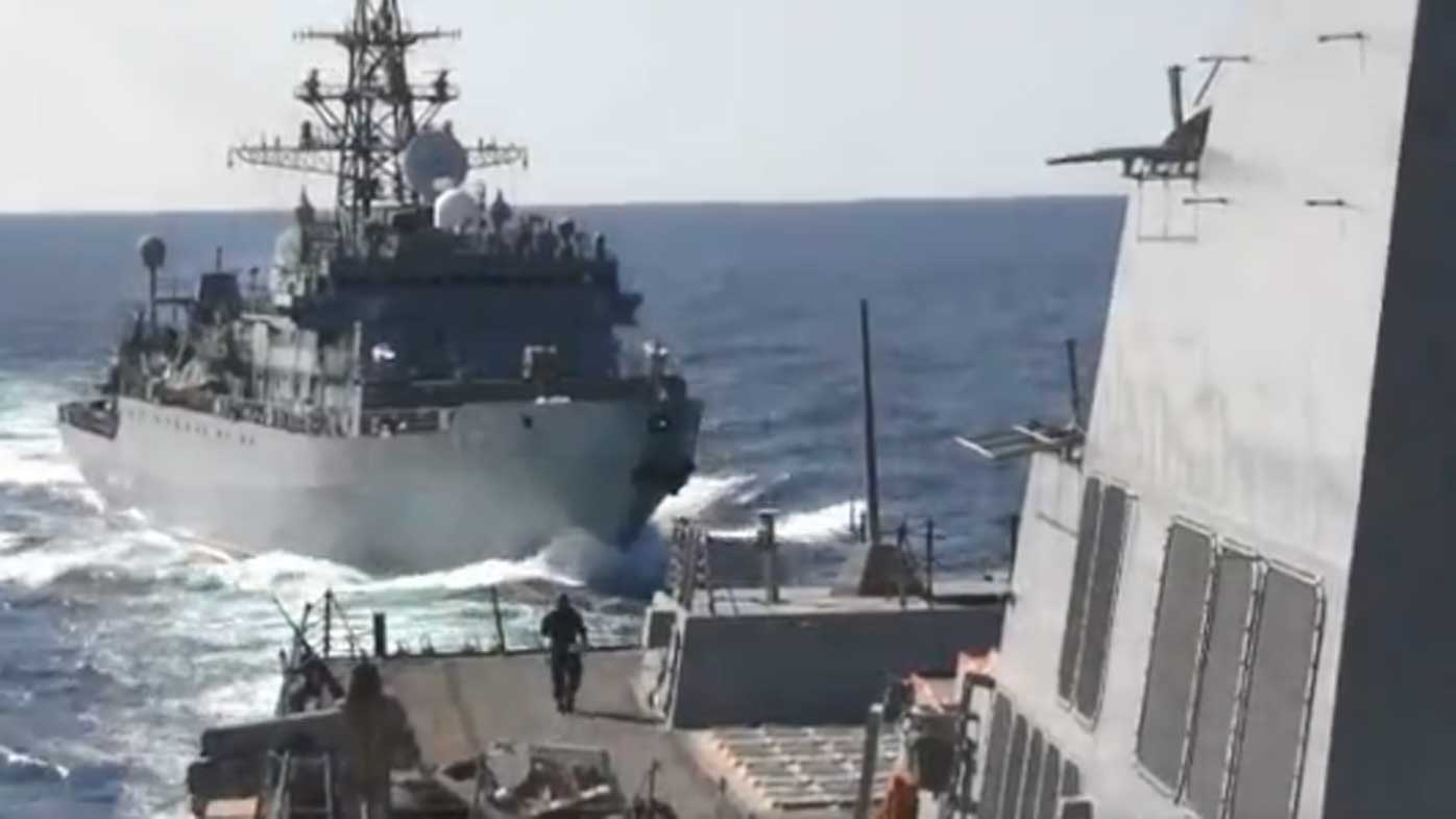 Footage from the US Fifth Fleet shows the Russian ship narrowly closing in on the USS Farragut.