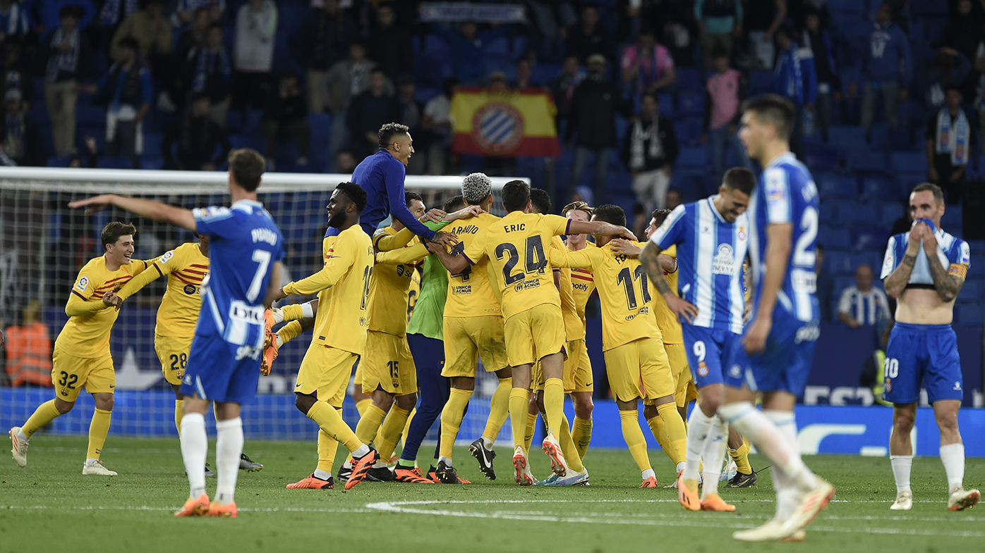 Barcelona players celebrate winning the Spanish league title after defeating Espanyol.