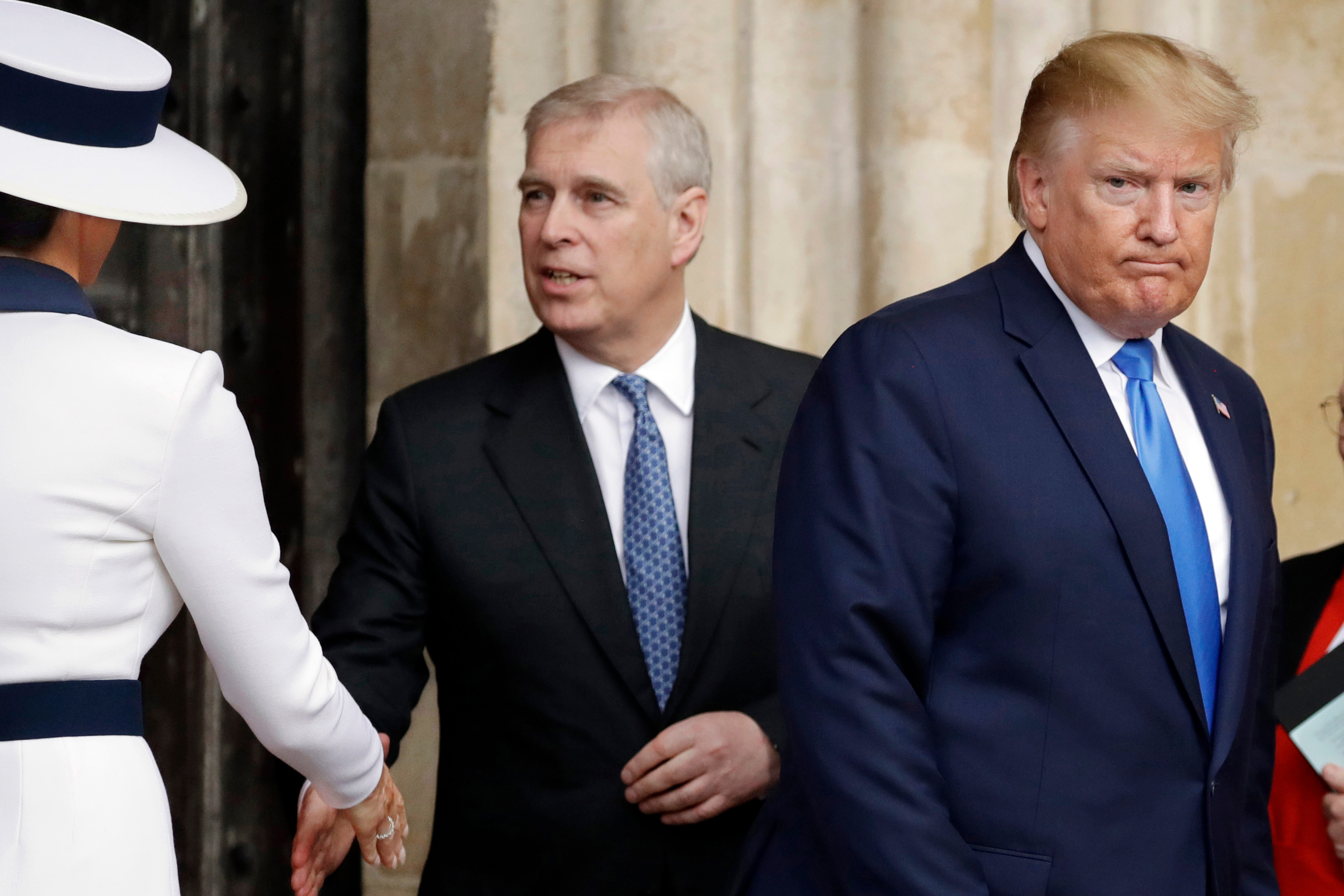 President Donald Trump, right, and first lady Melania Trump, left, accompanied by Britain's Prince Andrew, leave after a tour of Westminster Abbey in London, June 3, 2019.