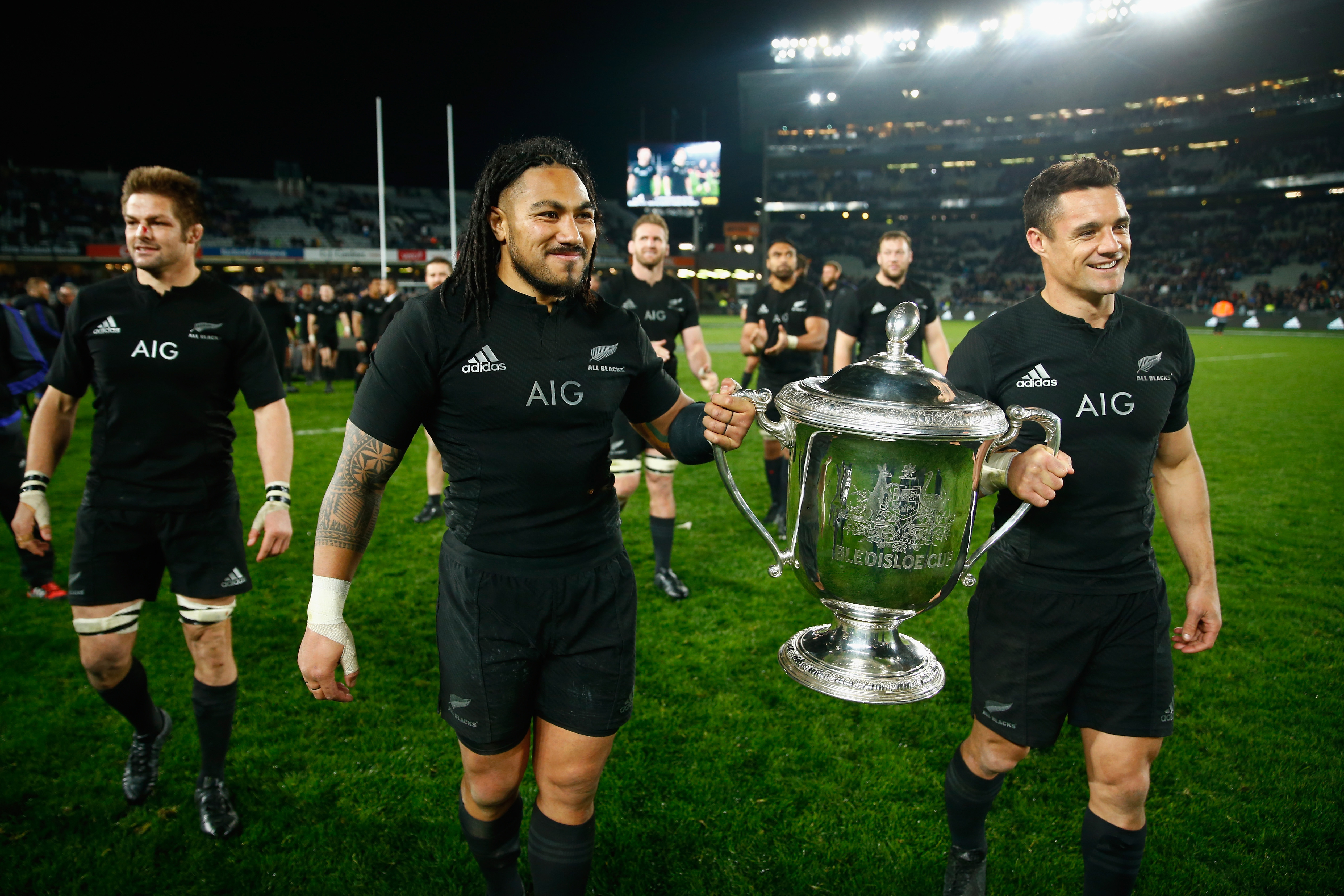 Dan Carter (right) carries the Webb Ellis Cup with Ma'a Nonu after winning the 2015 Rugby World Cup.