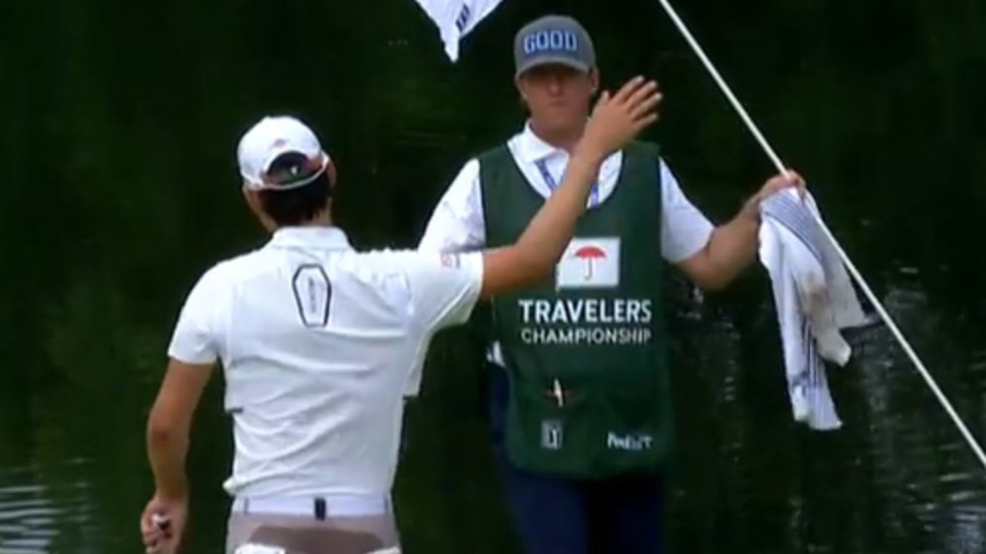 Min Woo Lee gives a high-five to his caddy after sinking a monster putt.