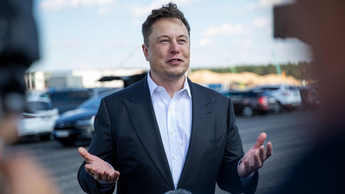 Tesla head Elon Musk talks to the press as he arrives at the construction site of the new Tesla Gigafactory near Berlin.