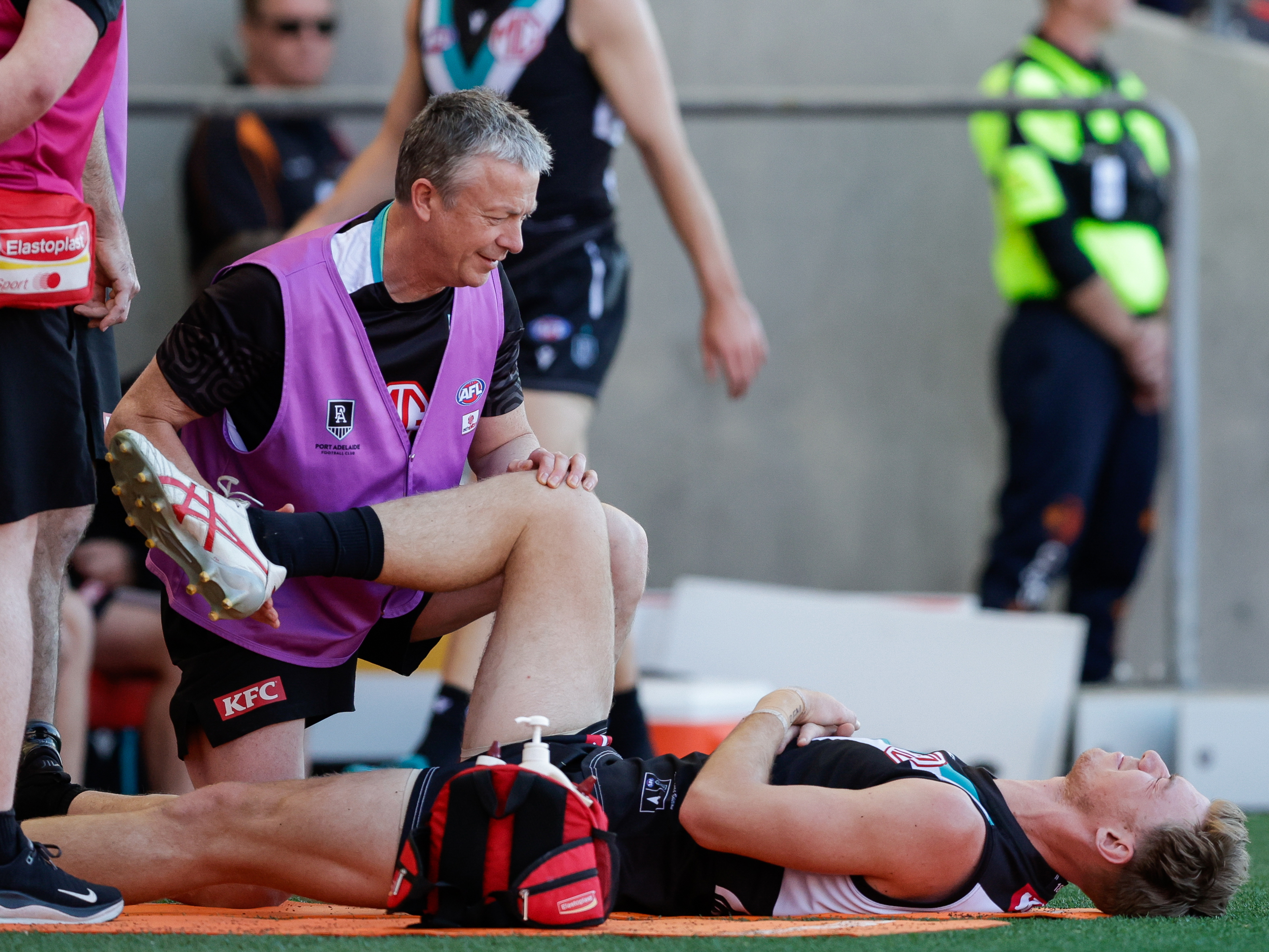 Port Adelaide's Todd Marshall was in agony as he was assessed for a hip inury against the Suns.