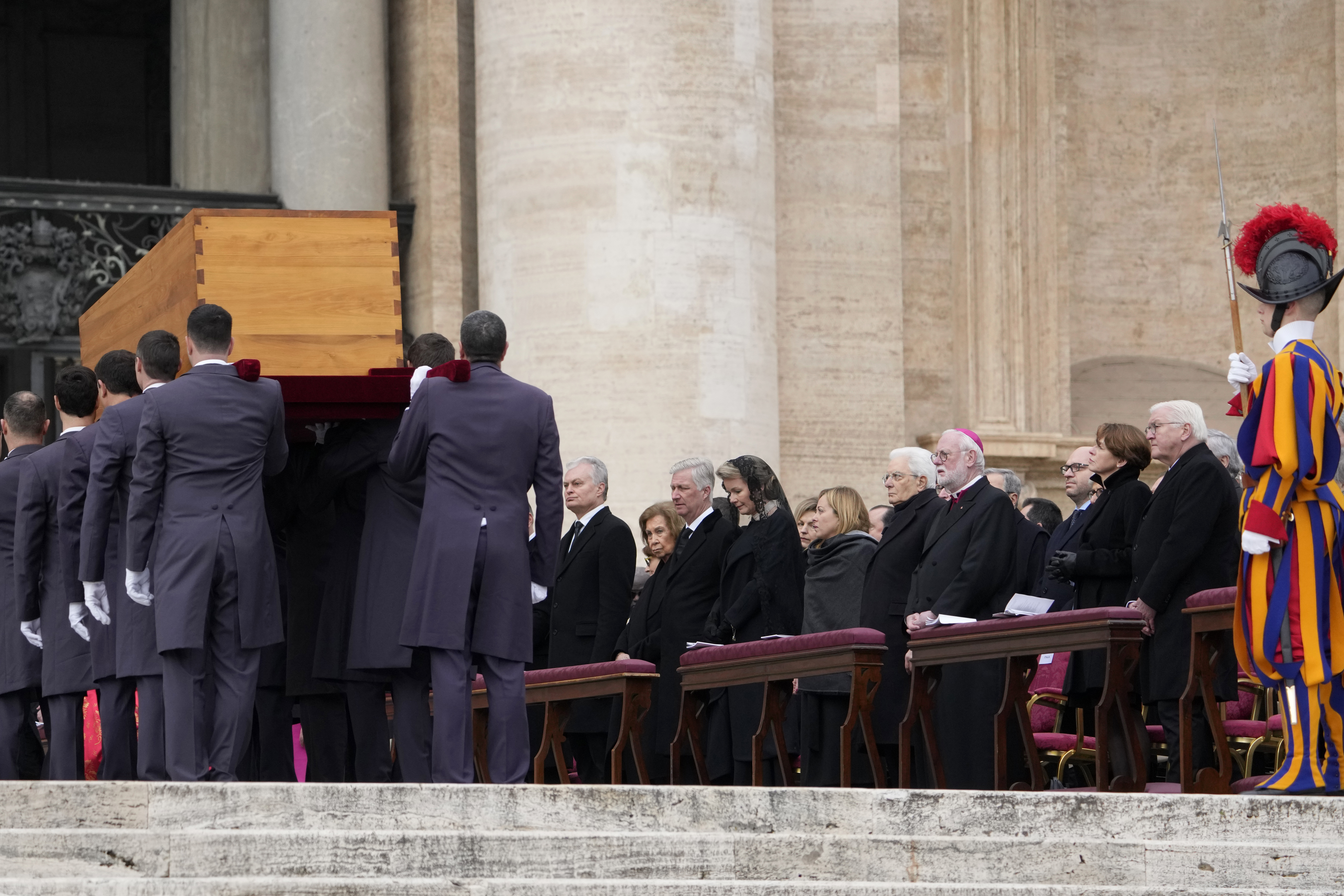 Dignitaries watch as the coffin of late Pope Emeritus Benedict XVI is carried away after a funeral mass in St. Peter's Square at the Vatican, Thursday, Jan. 5, 2023. 