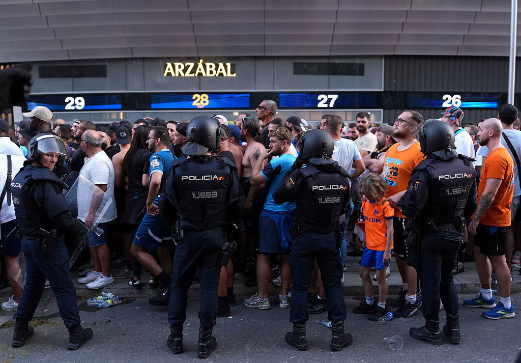 Fans and police are seen outside Estadio Santiago Bernabeu.
