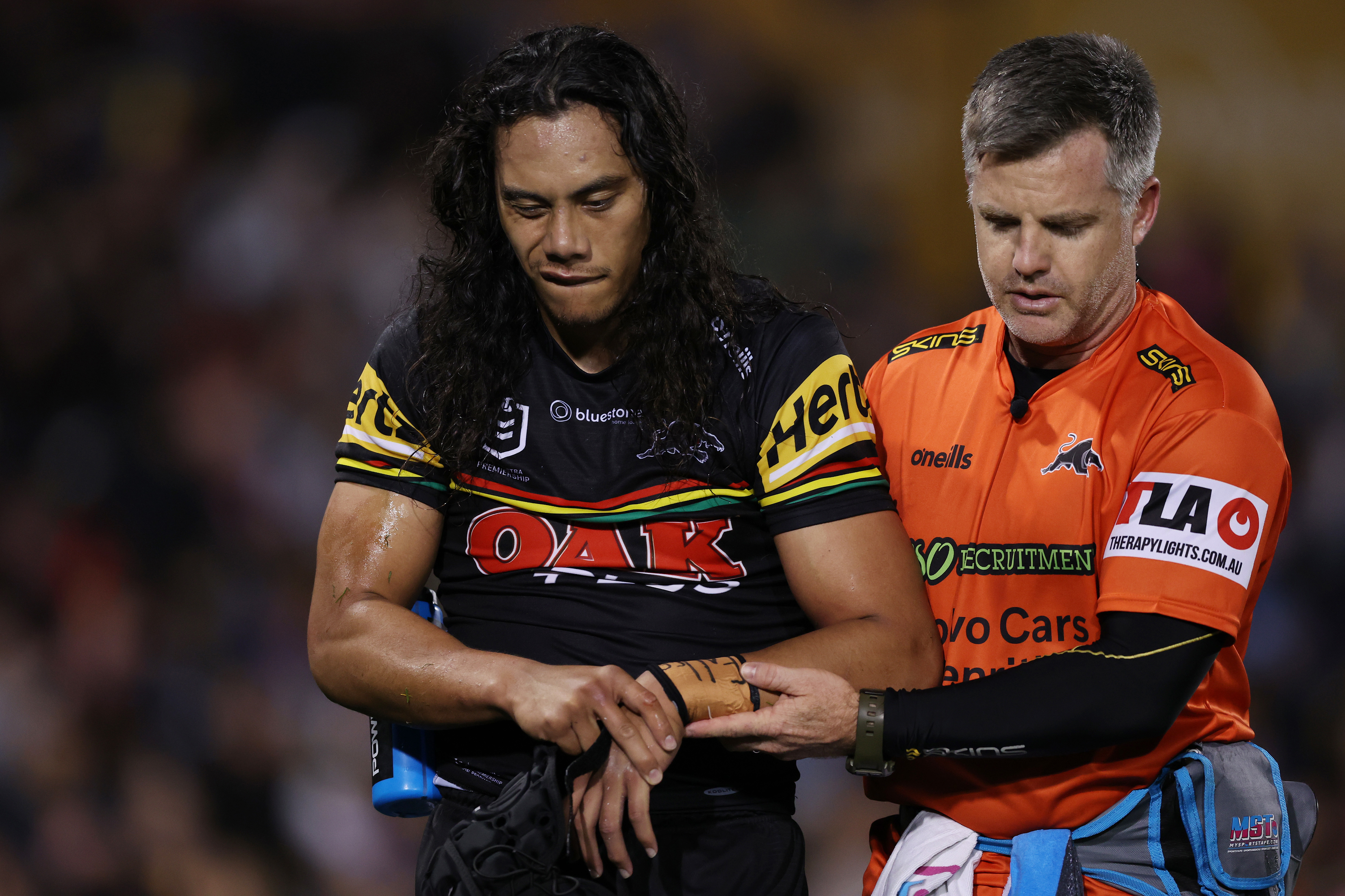 Jerome Luai of the Panthers is assisted from the field after sustaining an injury during the round 26 NRL match between Penrith Panthers and Parramatta Eels at BlueBet Stadium on August 24, 2023 in Penrith, Australia. (Photo by Mark Metcalfe/Getty Images)