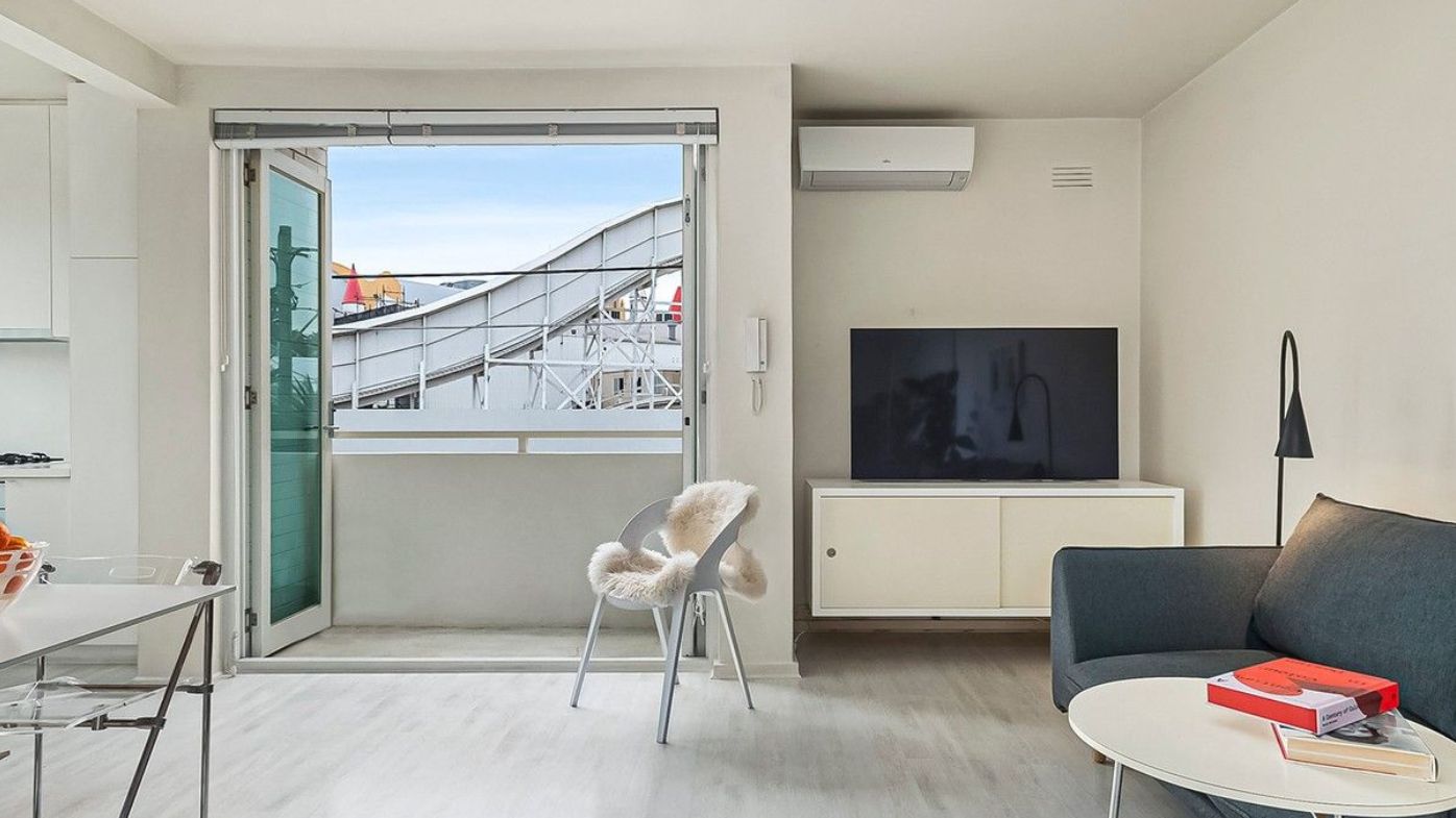 The rollercoaster swoops past the balcony at 10/19 Shakespeare Grove, St Kilda apartment Domain affordable