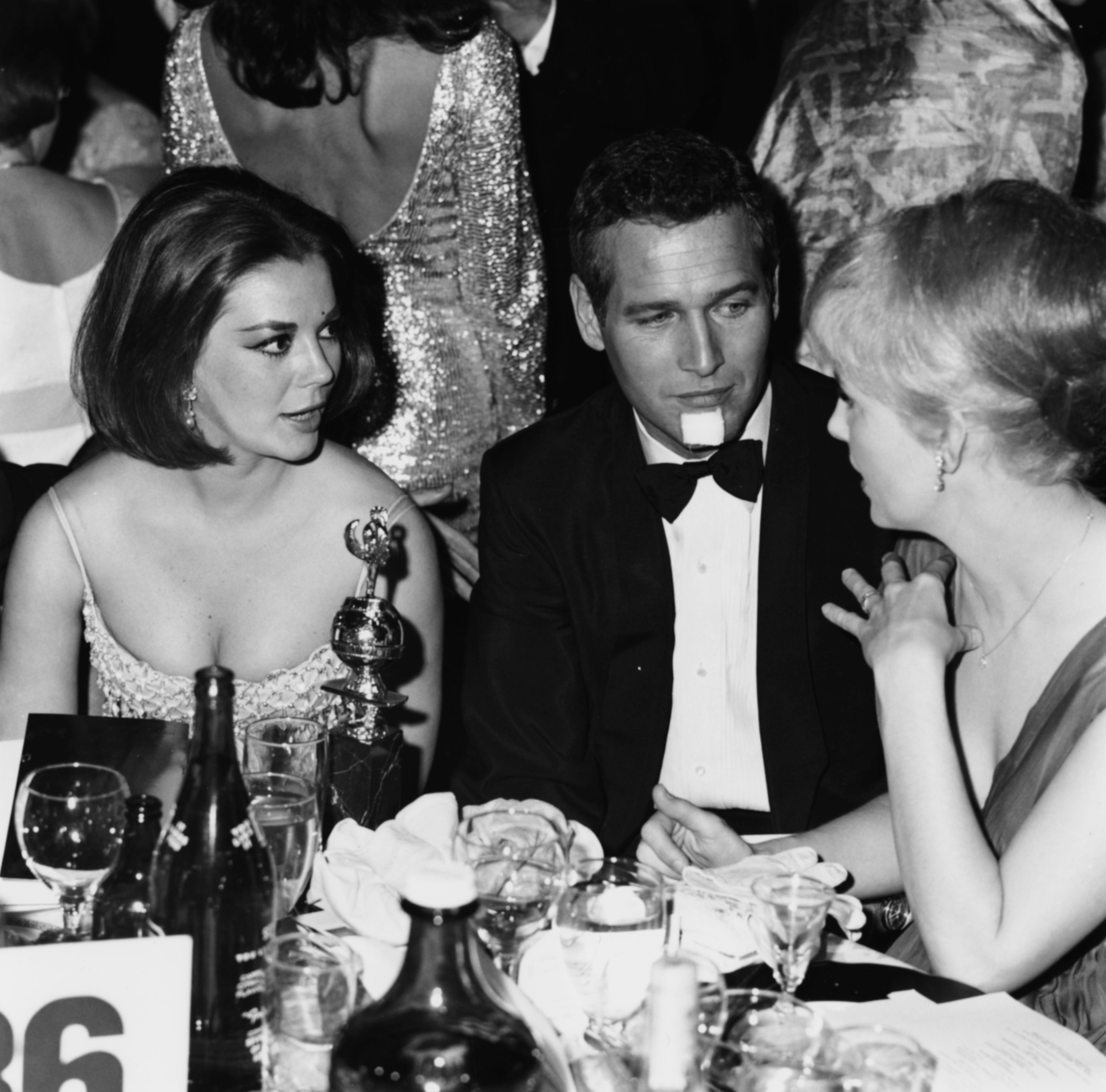 Natalie Wood, Paul Newman and Joanne Woodward sitting at their table at the Golden Globe Awards, 1965. 