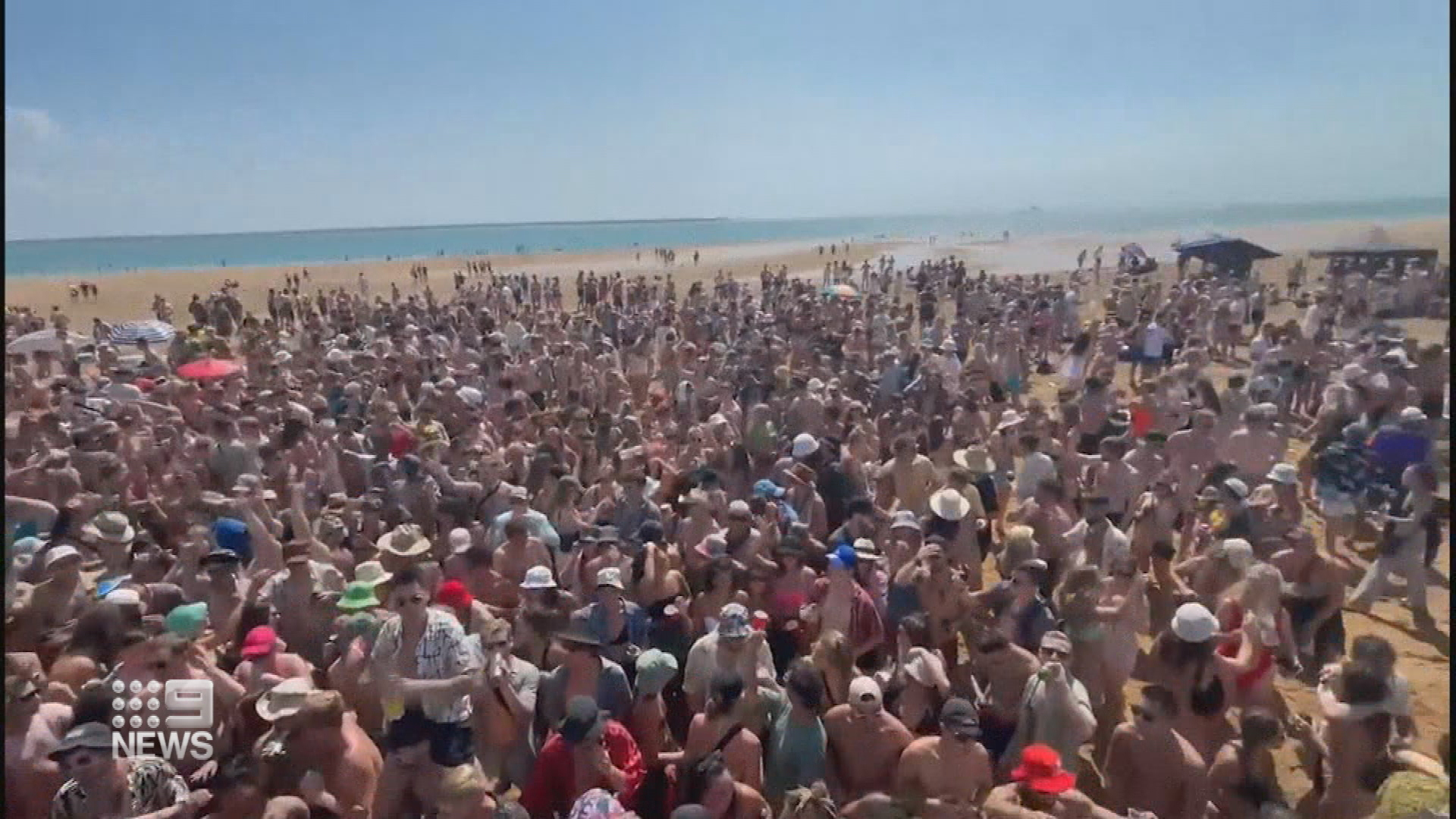 Revellers packed onto a sandbar in Darwin.