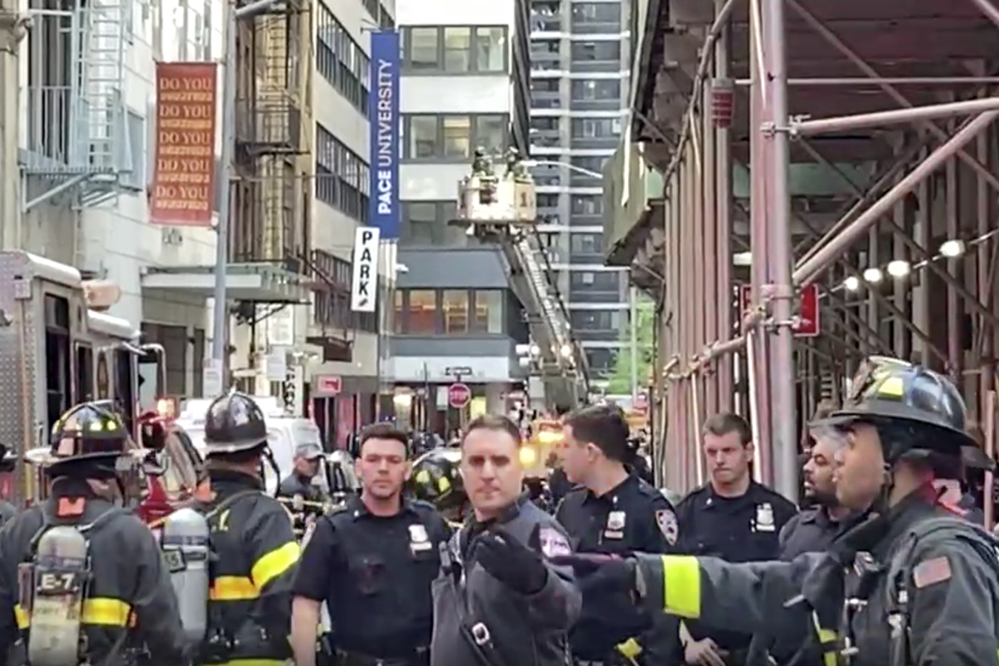 New York City Police and Fire Department personnel cordon off an area in New York's Financial District near the site of a partially collapsed parking garage. 