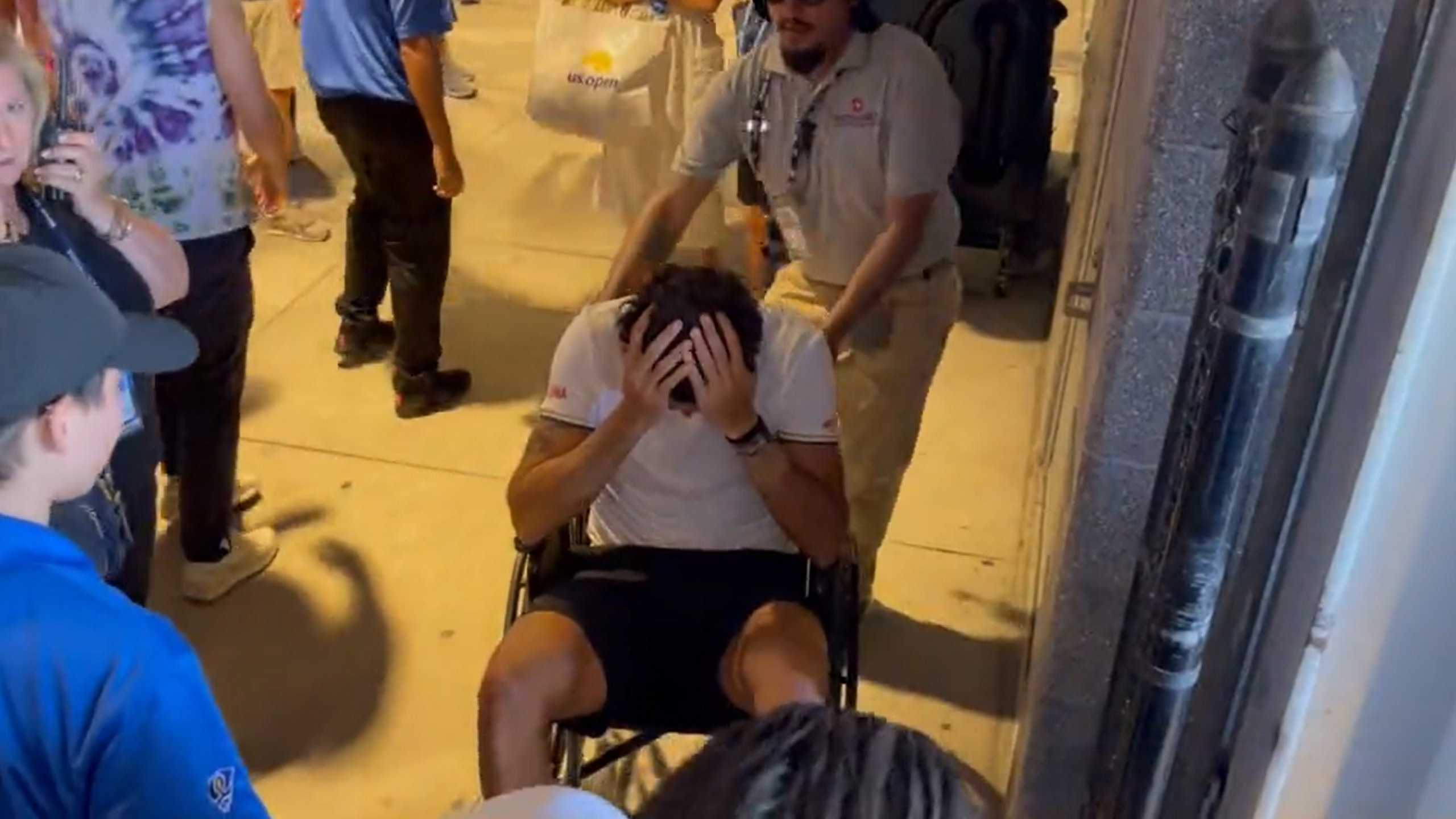 Matteo Berrettini drops his hands into his head after rolling his ankle at the US Open, forcing him to retire.