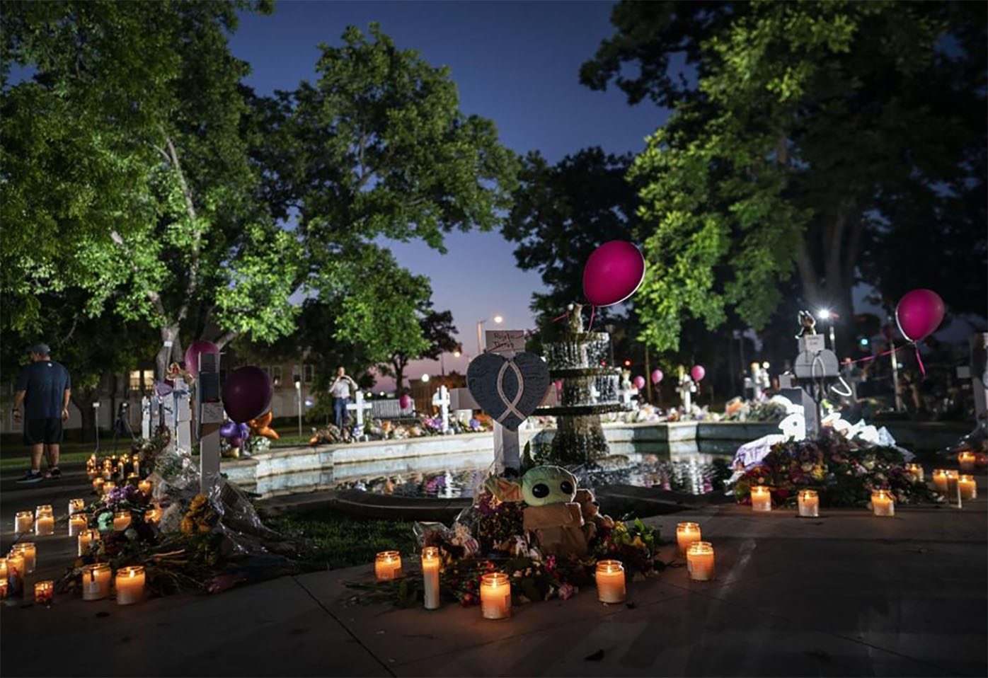 Candles are lit at dawn at a memorial site in the town square for the victims killed in this week's Robb Elementary School shooting Friday, May 27, 2022, in Uvalde, Texas.
