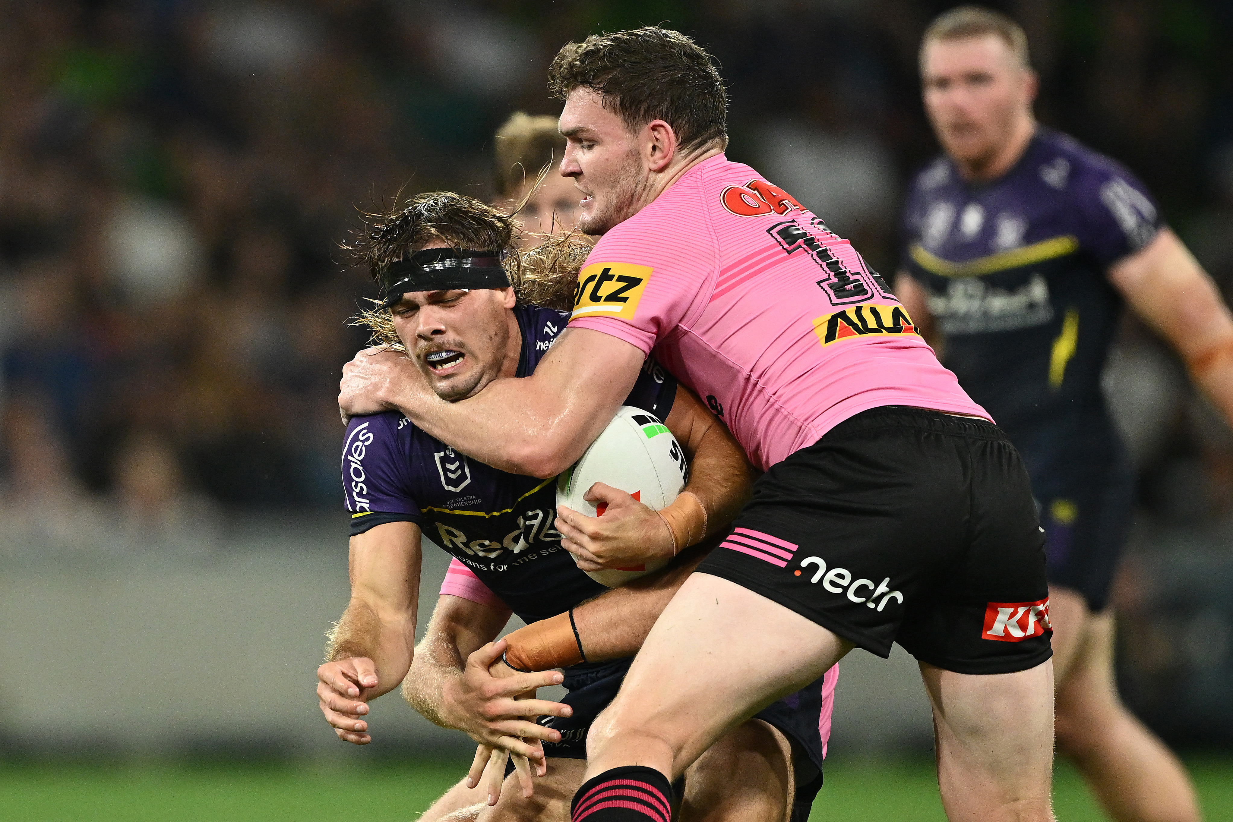 Ryan Papenhuyzen of the Storm is tackled by Liam Martin of Penrith.