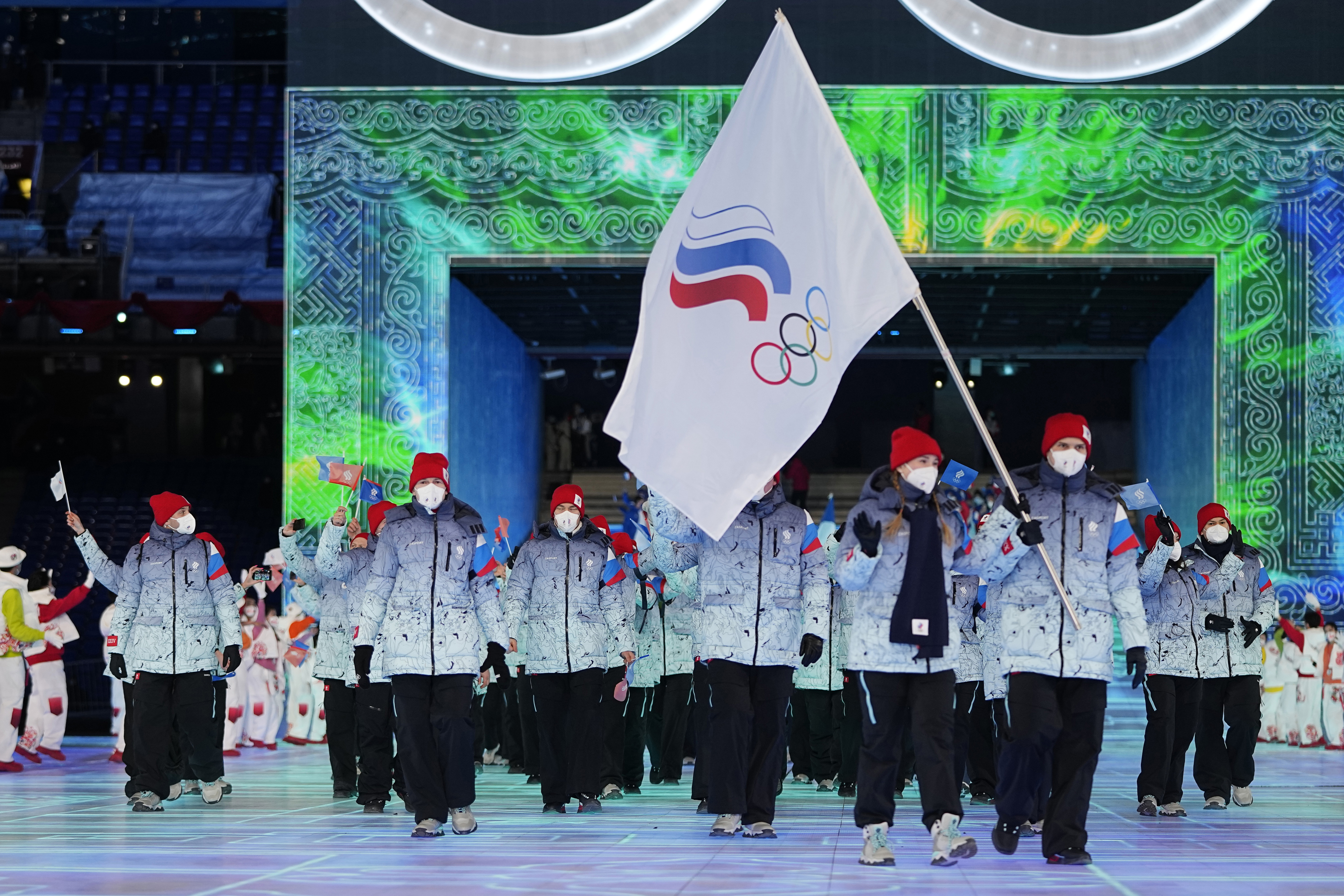 FILE- Olga Fatkulina and Vadim Shipachyov, of the Russian Olympic Committee, carry a flag into the stadium during the opening ceremony of the 2022 Winter Olympics, on Feb. 4, 2022, in Beijing, where Russian athletes competed under the acronym ROC, for Russian Olympic Committee, for the third time. Ukrainian President Volodymyr Zelenskyy, who has previously said any neutral flag for Russia would be stained with blood, is set to address a group of sports ministers meeting to discuss Russian partic