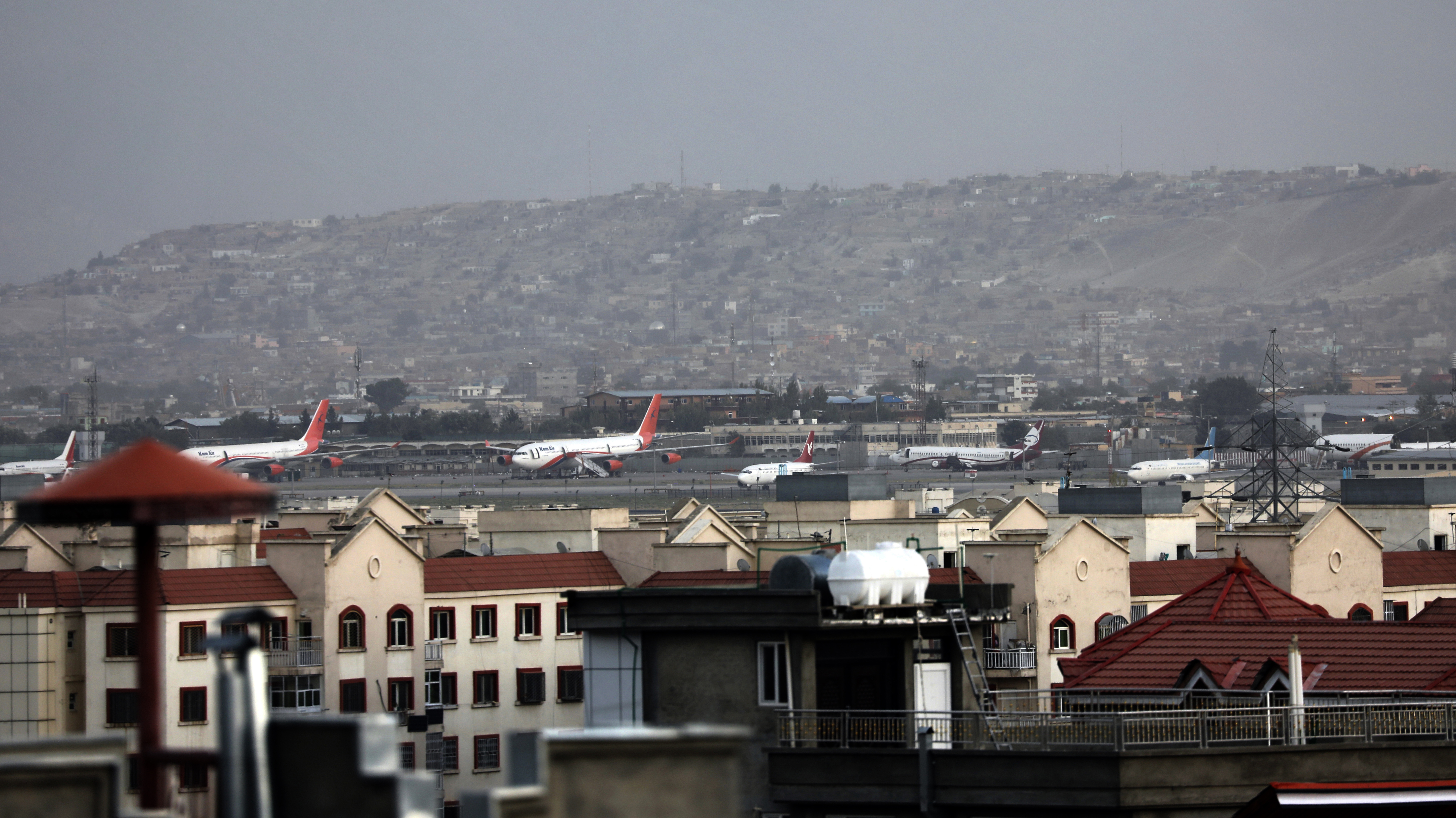 Airplanes are parked on the tarmac after a deadly explosion outside the airport in Kabul, Afghanistan.